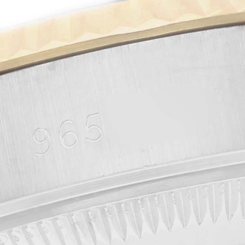 This close-up shows the side of a Rolex Datejust 69173 Women
s Steel and Gold (two tone) Champagne Dial 69173 Women
s Steel and Gold (two tone) Champagne Dial, focusing on the case and serial number engraving.