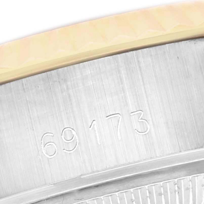 The image shows a close-up of the case side of a Rolex Datejust 69173 Women
s Steel and Gold (two tone) Champagne Dial 69173 Women
s Steel and Gold (two tone) Champagne Dial, highlighting the engraved model number.