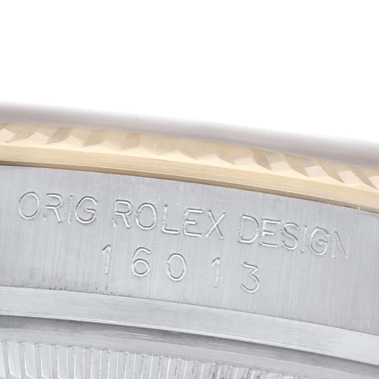 The image shows the side of a Rolex Datejust 16013 Men
s Steel and Gold (two tone) Champagne Dial 16013 Men
s Steel and Gold (two tone) Champagne Dial watch, highlighting the engraved model number "16013" and "ORIG ROLEX DESIGN" on the case.