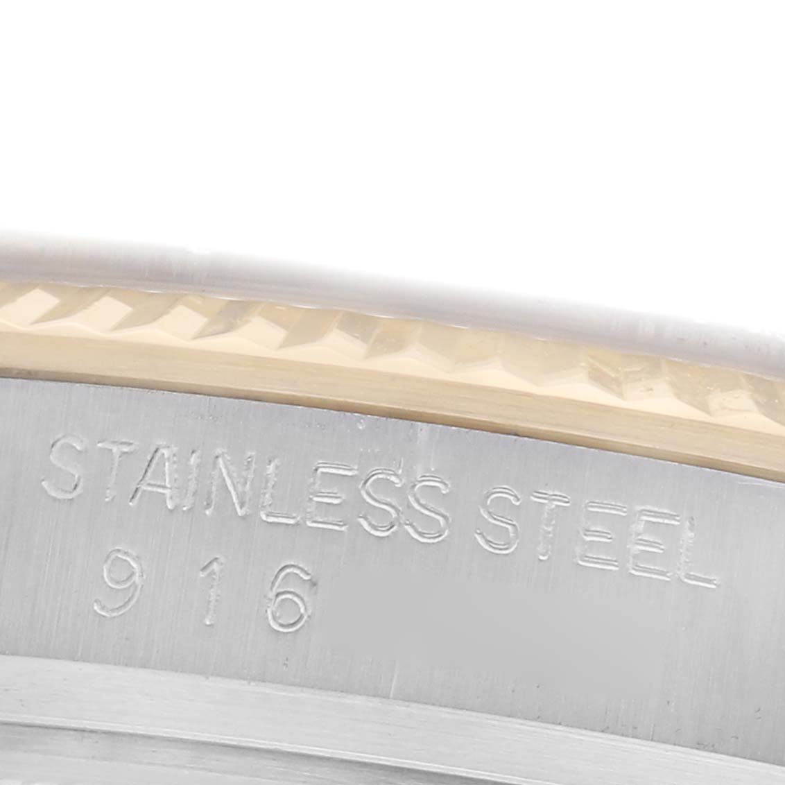 The image shows a close-up of the case edge and engraving on the Rolex Datejust 16013 Men
s Steel and Gold (two tone) Champagne Dial 16013 Men
s Steel and Gold (two tone) Champagne Dial watch, highlighting the "Stainless Steel" text.