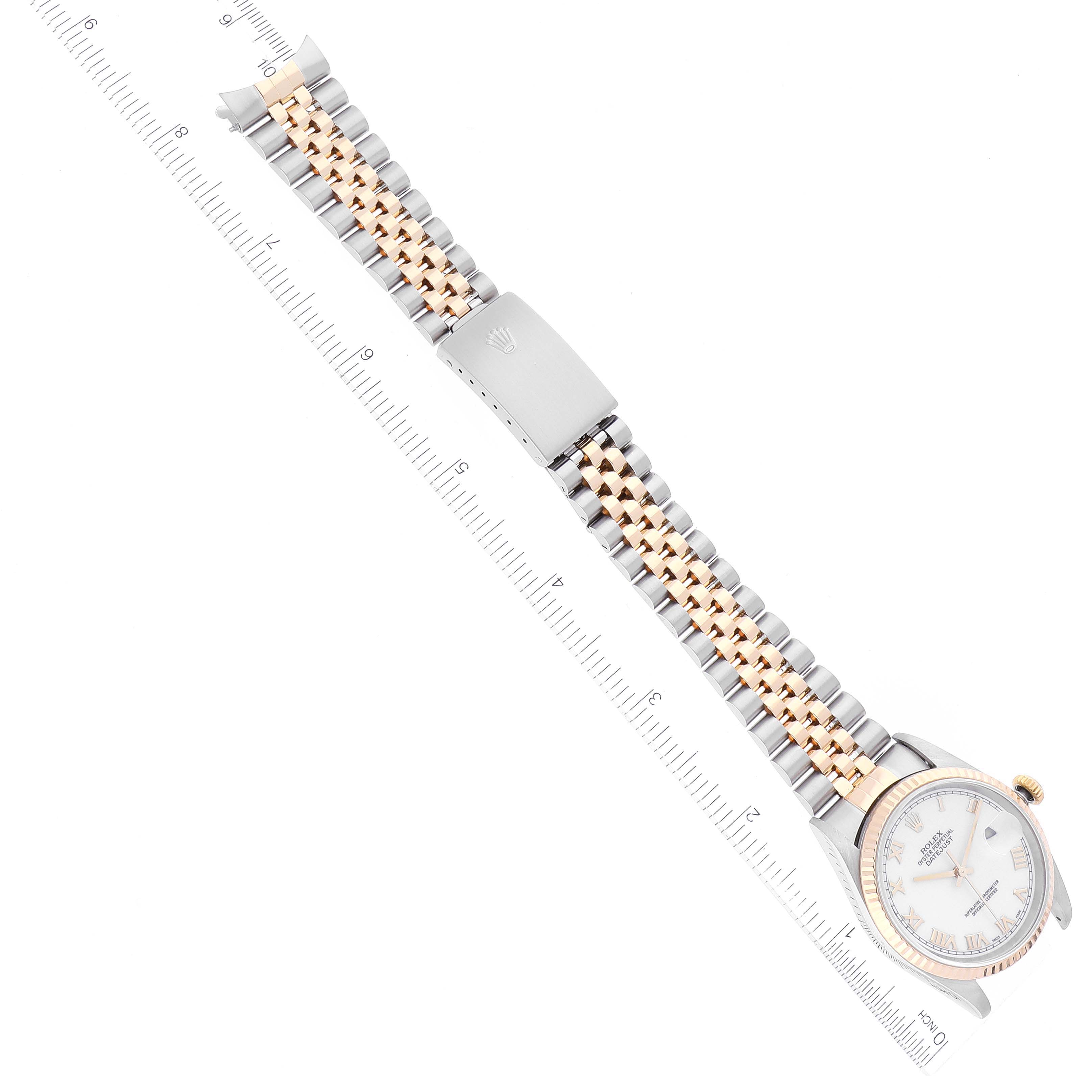 The image shows a top-down view of a Rolex Datejust 16233 Men's Steel and Gold (two tone) White Dial 16233 Men's Steel and Gold (two tone) White Dial watch, including its bracelet and clasp, placed alongside a ruler.