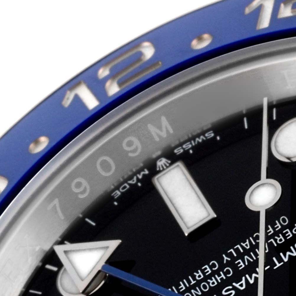 The image shows a close-up of the bezel and part of the dial of a Rolex GMT-Master 126710 Men
s Stainless Steel Black Dial 126710 Men
s Stainless Steel Black Dial watch, highlighting the 12-hour marker and second hand.