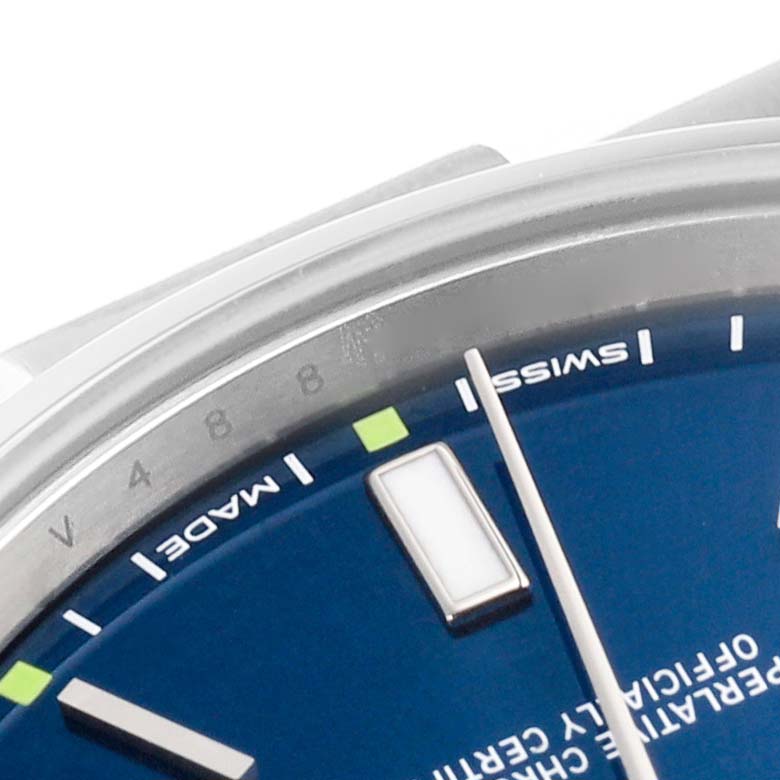 This close-up image shows the dial, hour markers, and part of the bezel of the Rolex Oyster Perpetual 114300 Men's Stainless Steel Blue Dial 114300 Men's Stainless Steel Blue Dial watch.