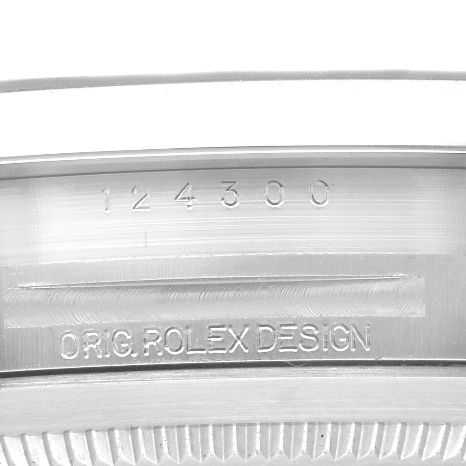 This image shows the case back engraving of a Rolex Oyster Perpetual 124300 Men
s Stainless Steel Red Dial 124300 Men
s Stainless Steel Red Dial, displaying the model number and "ORIG ROLEX DESIGN."