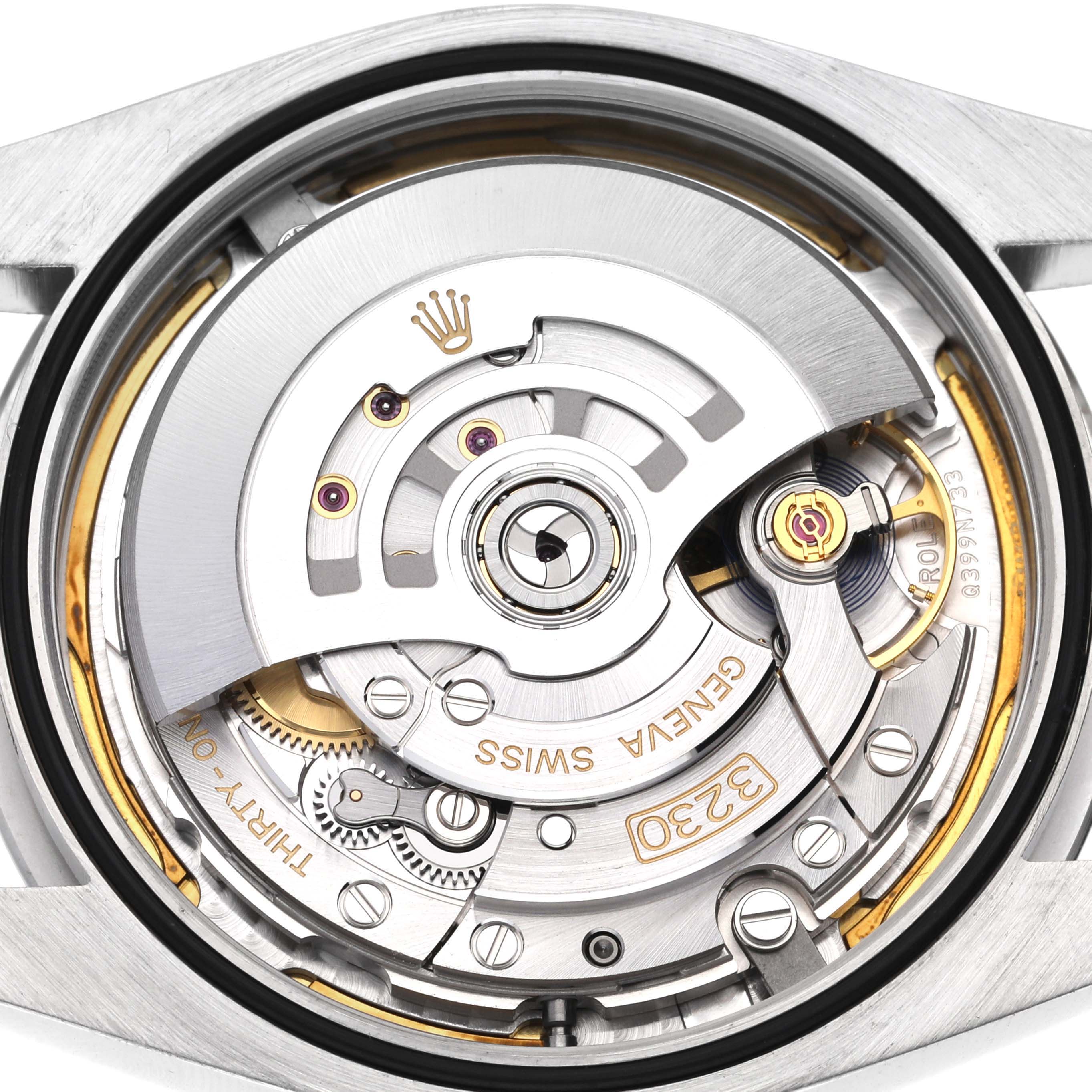 The image shows the intricate movement of a Rolex Oyster Perpetual 124300 Men
s Stainless Steel Red Dial 124300 Men
s Stainless Steel Red Dial watch from a top-down angle, revealing its internal mechanics.