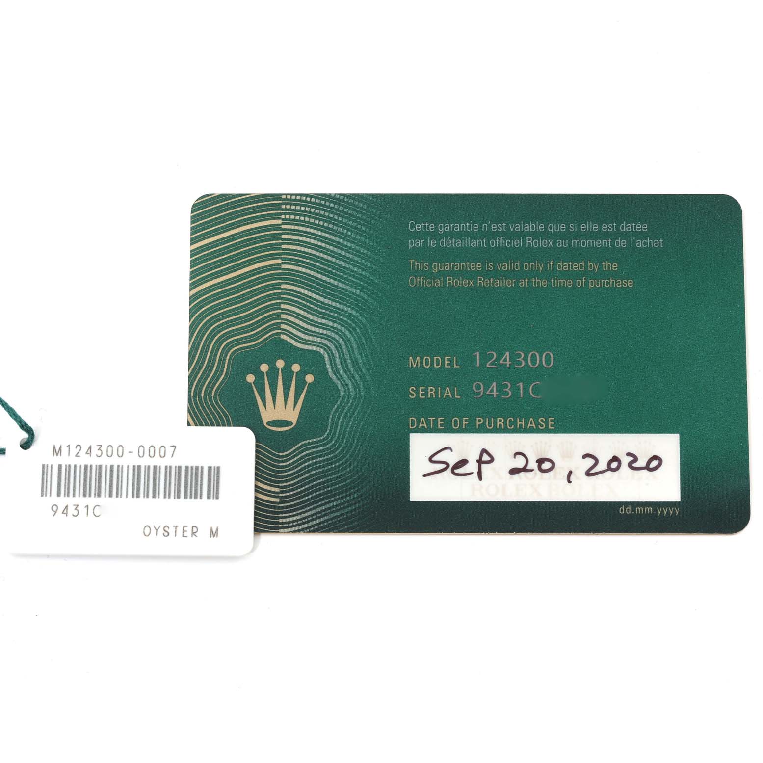 The image shows the warranty card and tag of a Rolex Oyster Perpetual 124300 Men
s Stainless Steel Red Dial 124300 Men
s Stainless Steel Red Dial model 124300 watch.