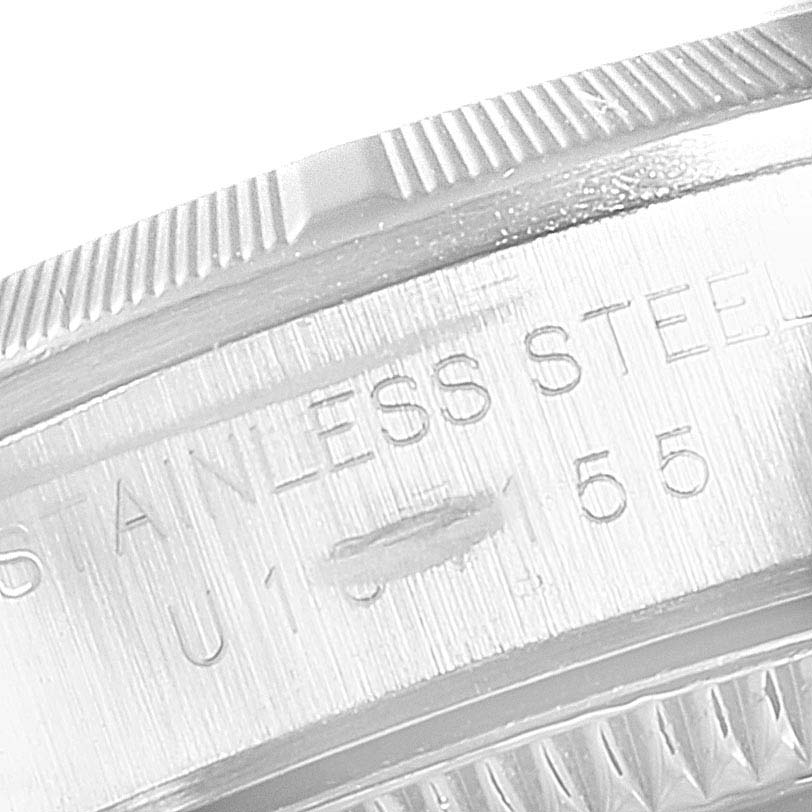 This close-up image shows the engraved stainless steel part of the Rolex Oyster Perpetual 67230 Women
s Stainless Steel Black Dial 67230 Women
s Stainless Steel Black Dial watch case.