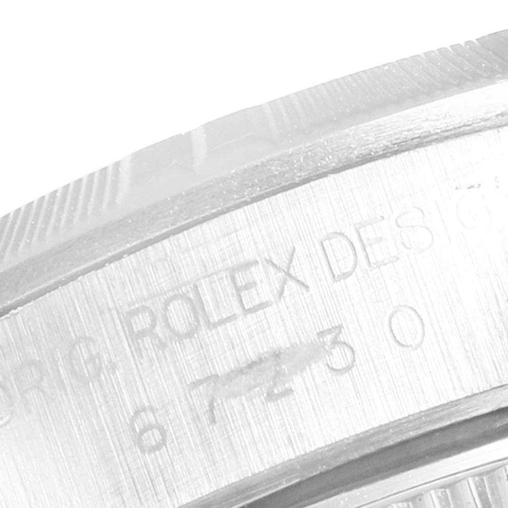 This close-up image shows the engraved side of a Rolex Oyster Perpetual 67230 Women
s Stainless Steel Black Dial 67230 Women
s Stainless Steel Black Dial watch case.