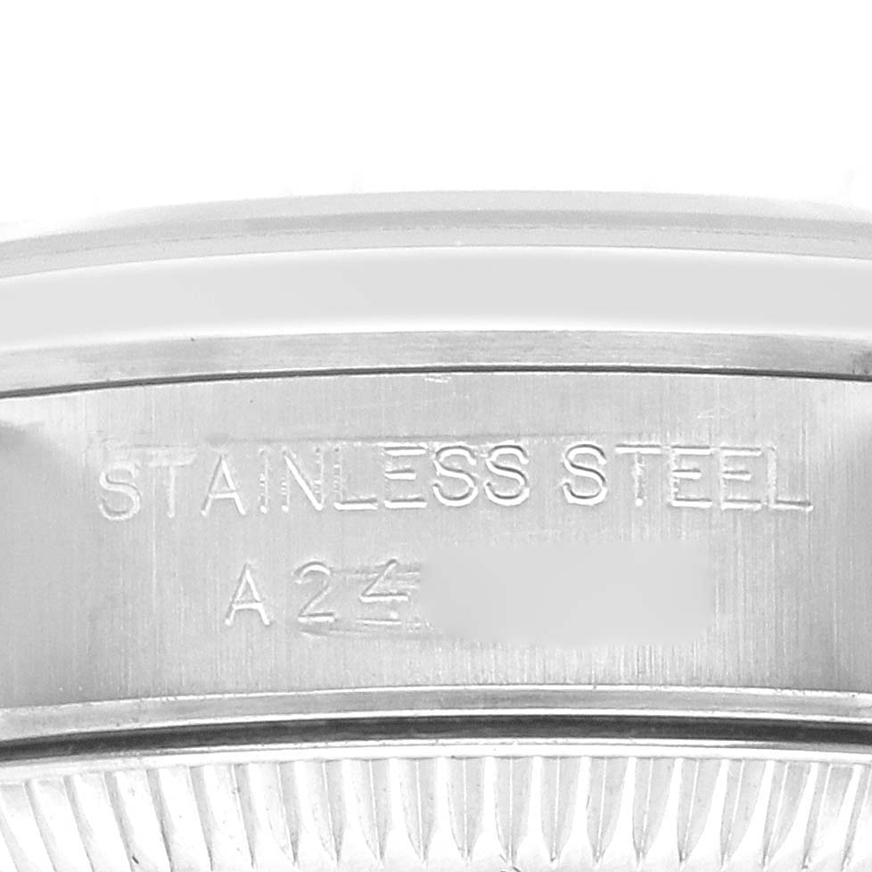The image shows the side of the case back for an Oyster Perpetual by Rolex, highlighting the "Stainless Steel" engraving.