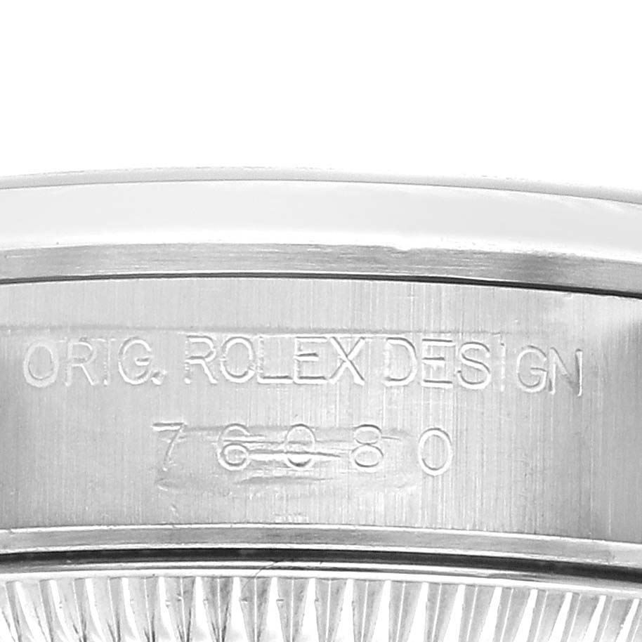 The image shows the side of the Rolex Oyster Perpetual 76080 Women
s Stainless Steel Black Dial 76080 Women
s Stainless Steel Black Dial watch case, featuring engraved model details.