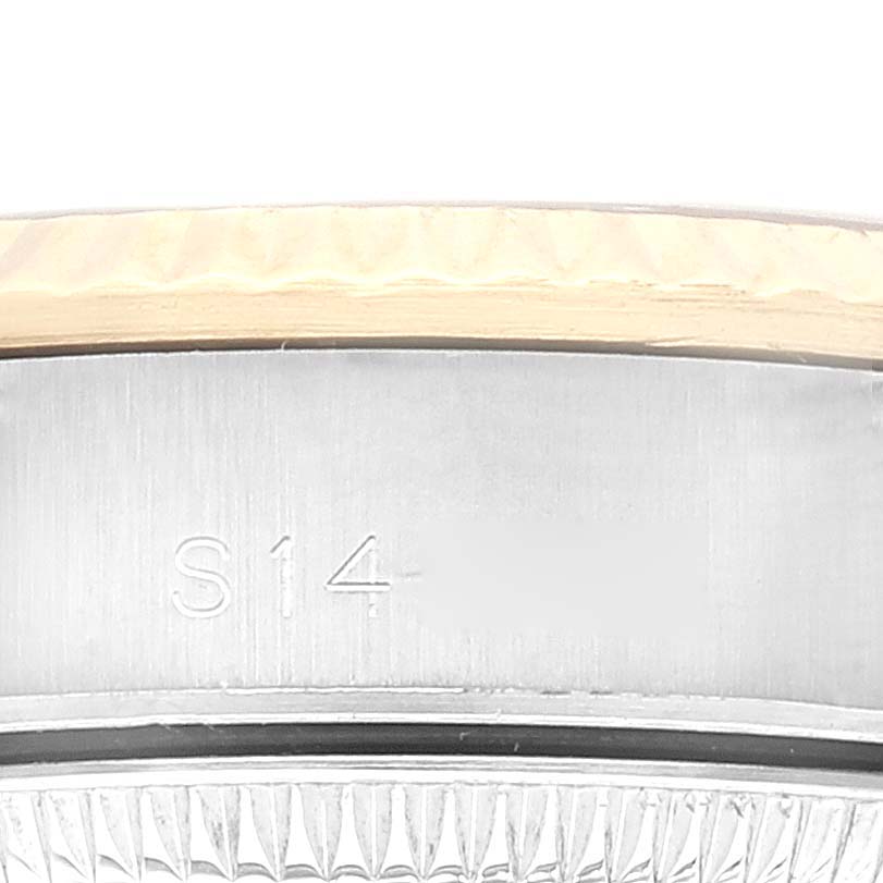 This image shows a close-up of the side of a Rolex Oyster Perpetual 67193 Women's Steel and Gold (two tone) Silver Dial 67193 Women's Steel and Gold (two tone) Silver Dial watch, highlighting part of the bezel and casing.