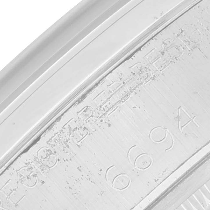 This close-up image shows the engraved serial number and details on the inner bezel of the Rolex Vintage Collection 6694 Men's Stainless Steel Silver Dial 6694 Men's Stainless Steel Silver Dial model watch.