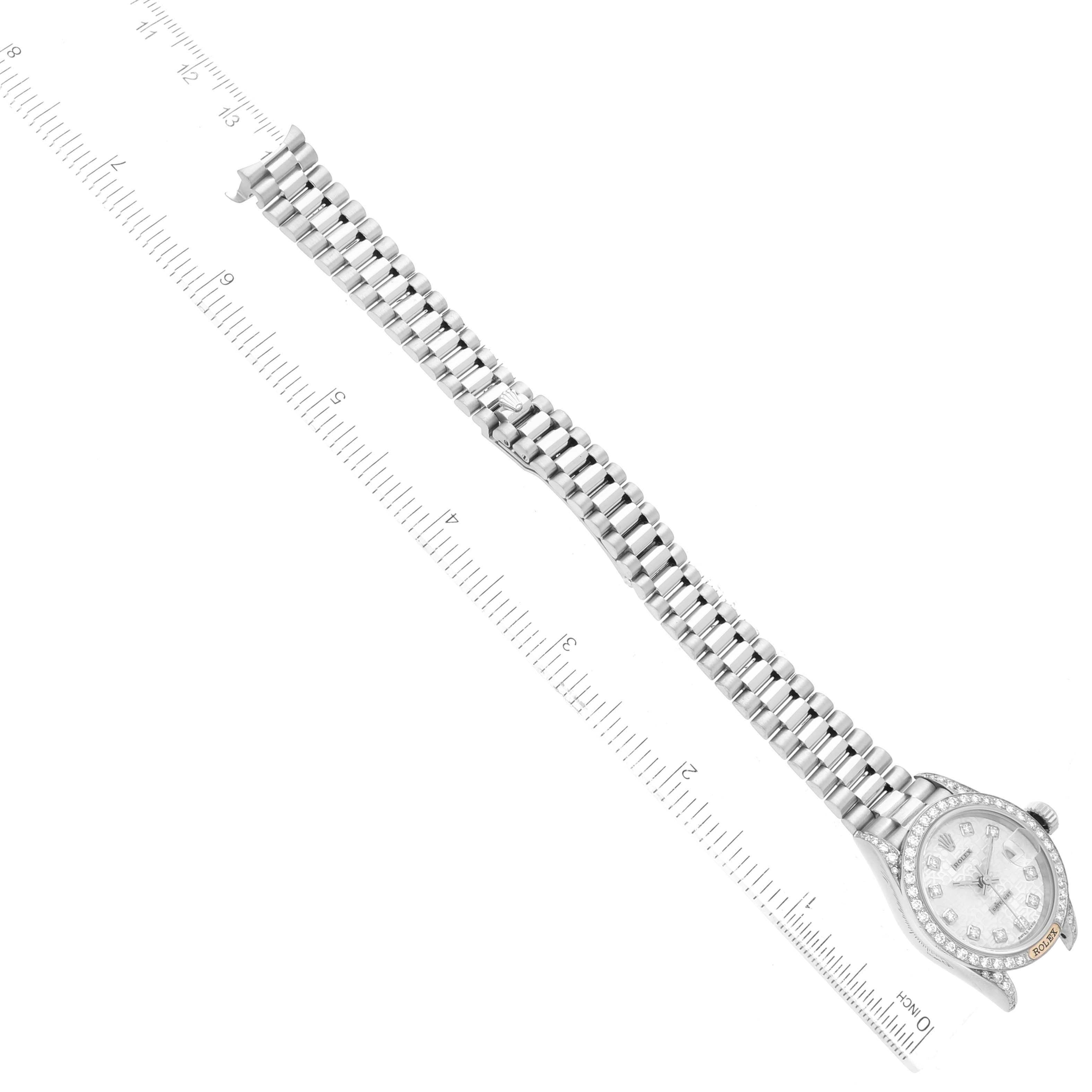 The image shows a top-down view of a Rolex President 69159 Women's White Gold Silver Dial 69159 Women's White Gold Silver Dial model watch, highlighting the bracelet and the face with a ruler for scale.