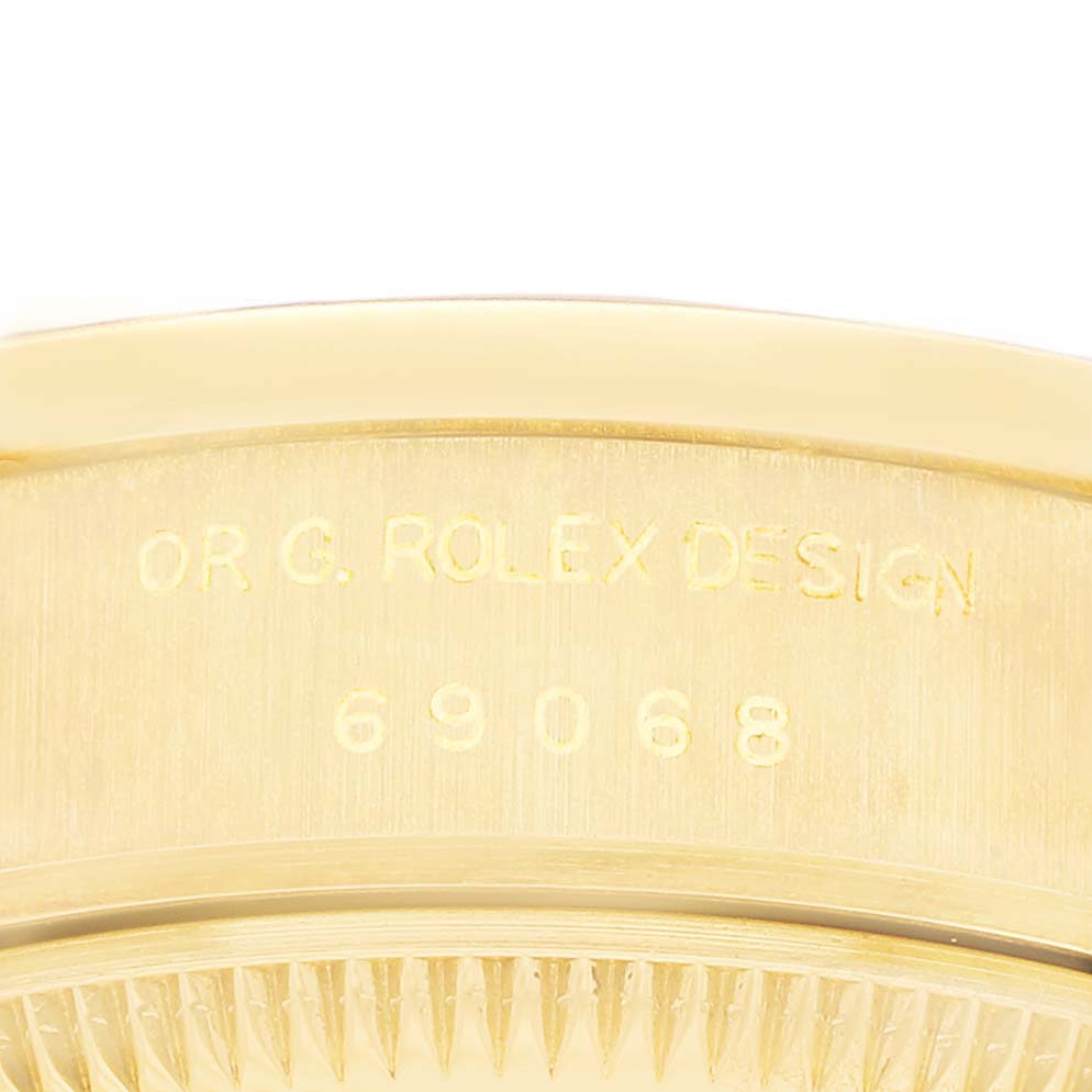 The image shows a close-up of the edge of the Rolex President 69068 Women's Yellow Gold Champagne Dial watch case, highlighting the model number engraved.
