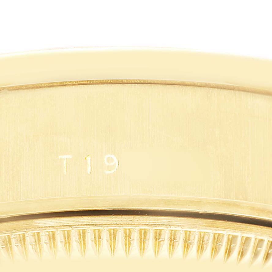 The image shows a close-up of the fluted bezel and edge of the case of the Rolex President 69068 Women's Yellow Gold Champagne Dial model, highlighting its texture and engraving.