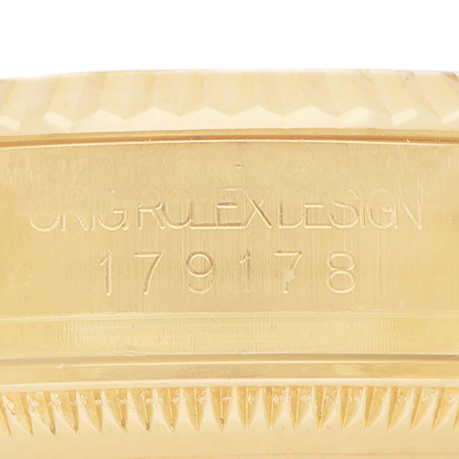 The image shows a close-up of the side of a Rolex President 179178 Men's Yellow Gold Mother of Pearl Dial watch, focusing on the engraved model number and ridged bezel.