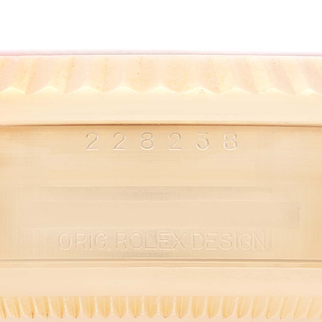 This close-up image shows the engraved serial numbers and "Roled Design" text on the case of a Rolex President 228238 Men
s Yellow Gold Champagne Dial 228238 Men
s Yellow Gold Champagne Dial model watch.