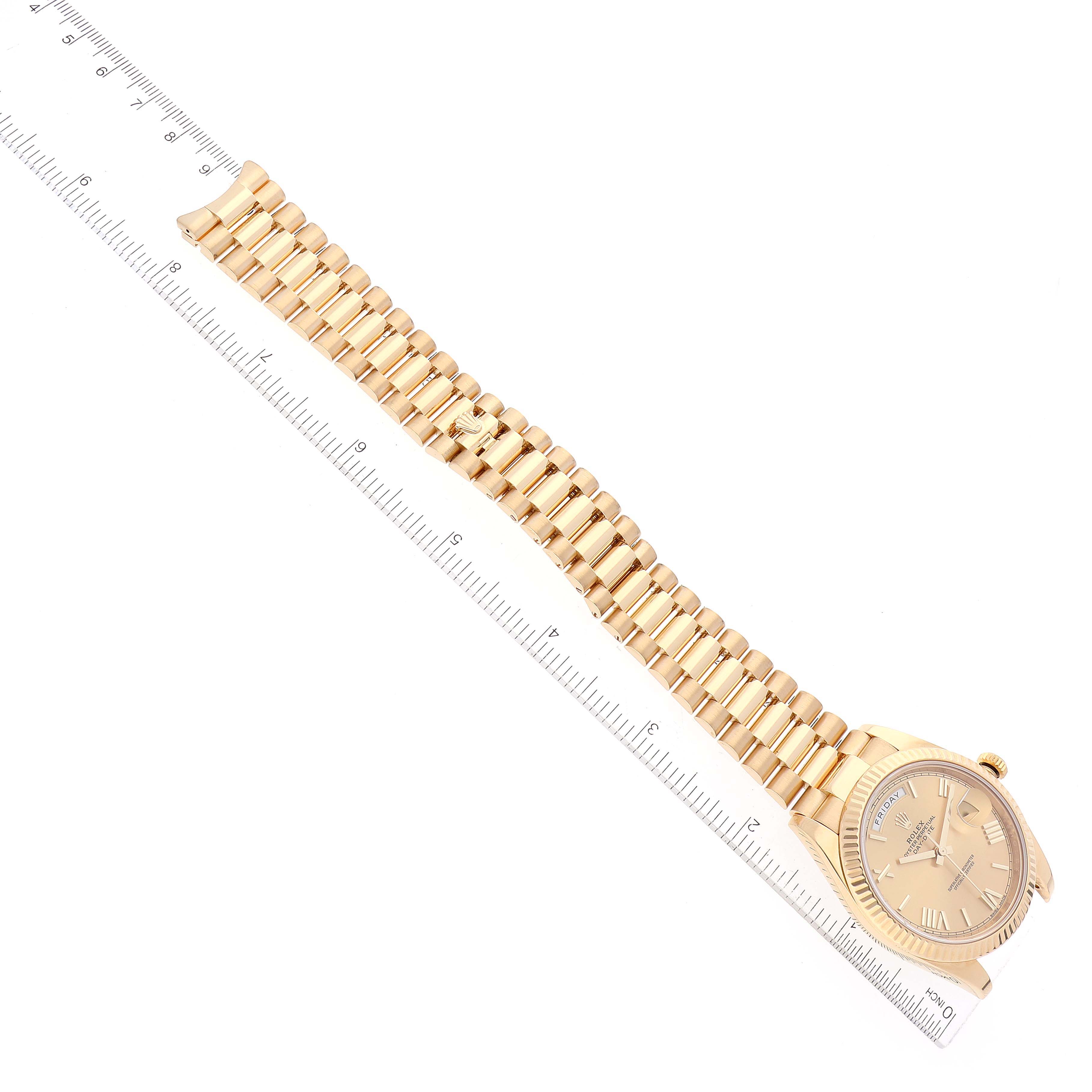 A Rolex President 228238 Men
s Yellow Gold Champagne Dial 228238 Men
s Yellow Gold Champagne Dial model watch shown from a top-down angle, with the entire band and watch face visible.