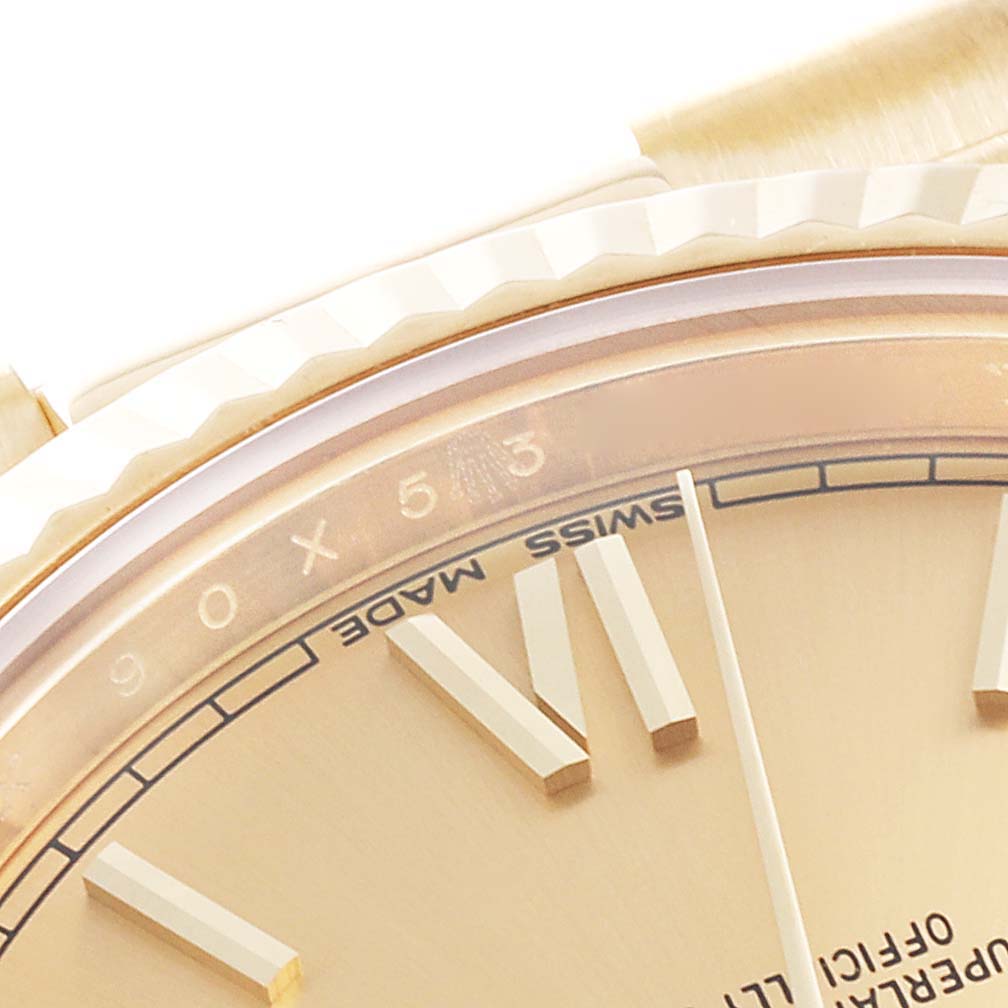 This close-up image of a Rolex President 228238 Men
s Yellow Gold Champagne Dial 228238 Men
s Yellow Gold Champagne Dial watch shows the bezel, part of the dial, and the numeral markers.