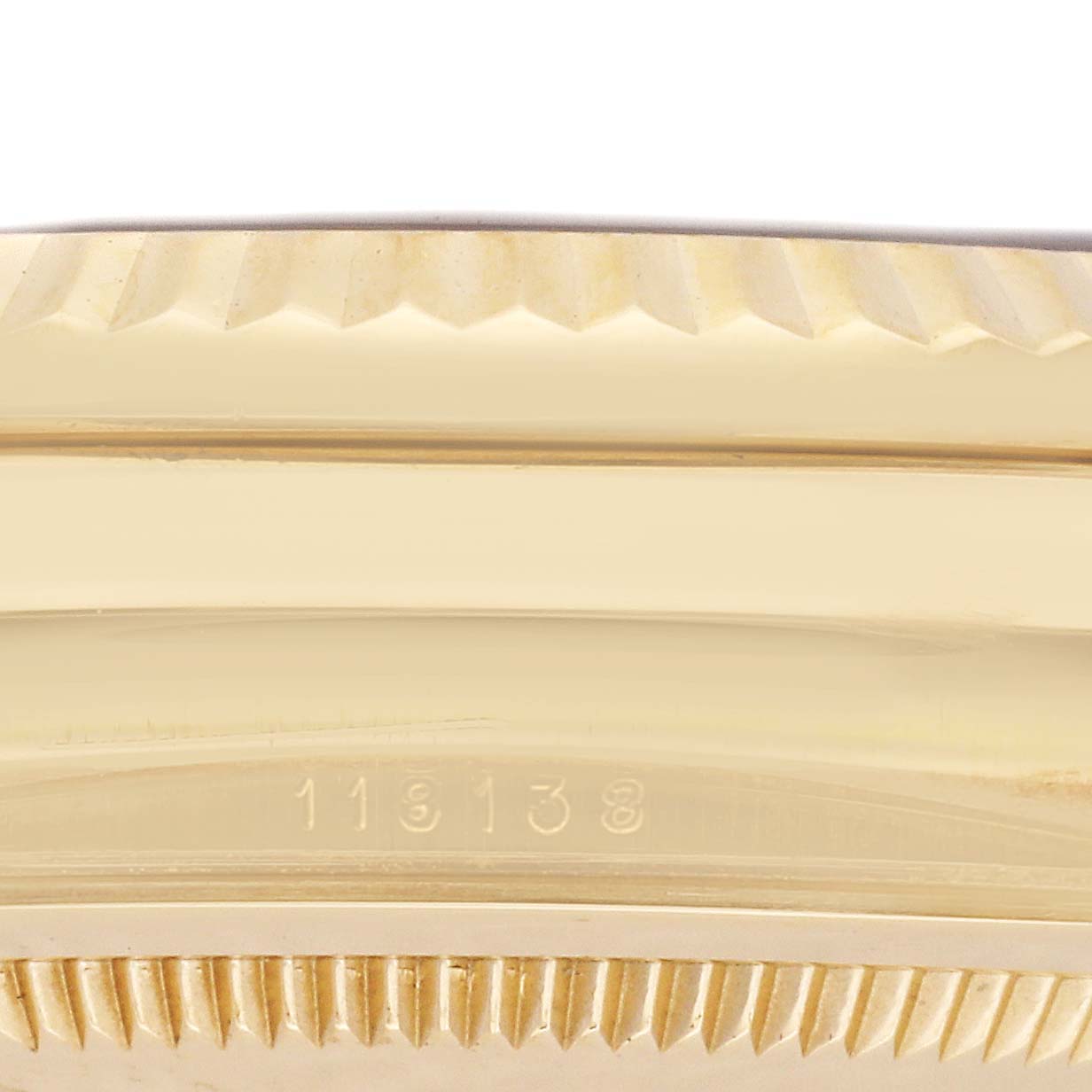 The image shows a close-up of the side of the bezel and case edge of a Rolex President 118138 Men
s Yellow Gold Green Dial 118138 Men
s Yellow Gold Green Dial model watch, with visible detailing.