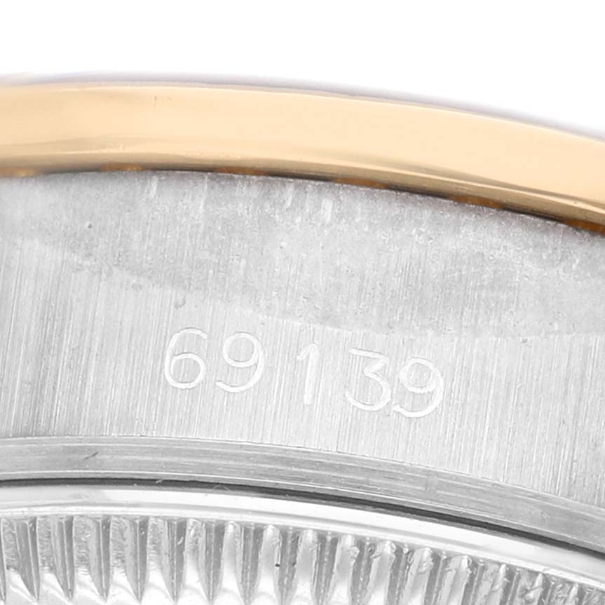 The image shows a close-up of the bezel and case edge of a Rolex President 69139 Women's White Gold Champagne Dial model, featuring gold and stainless steel.