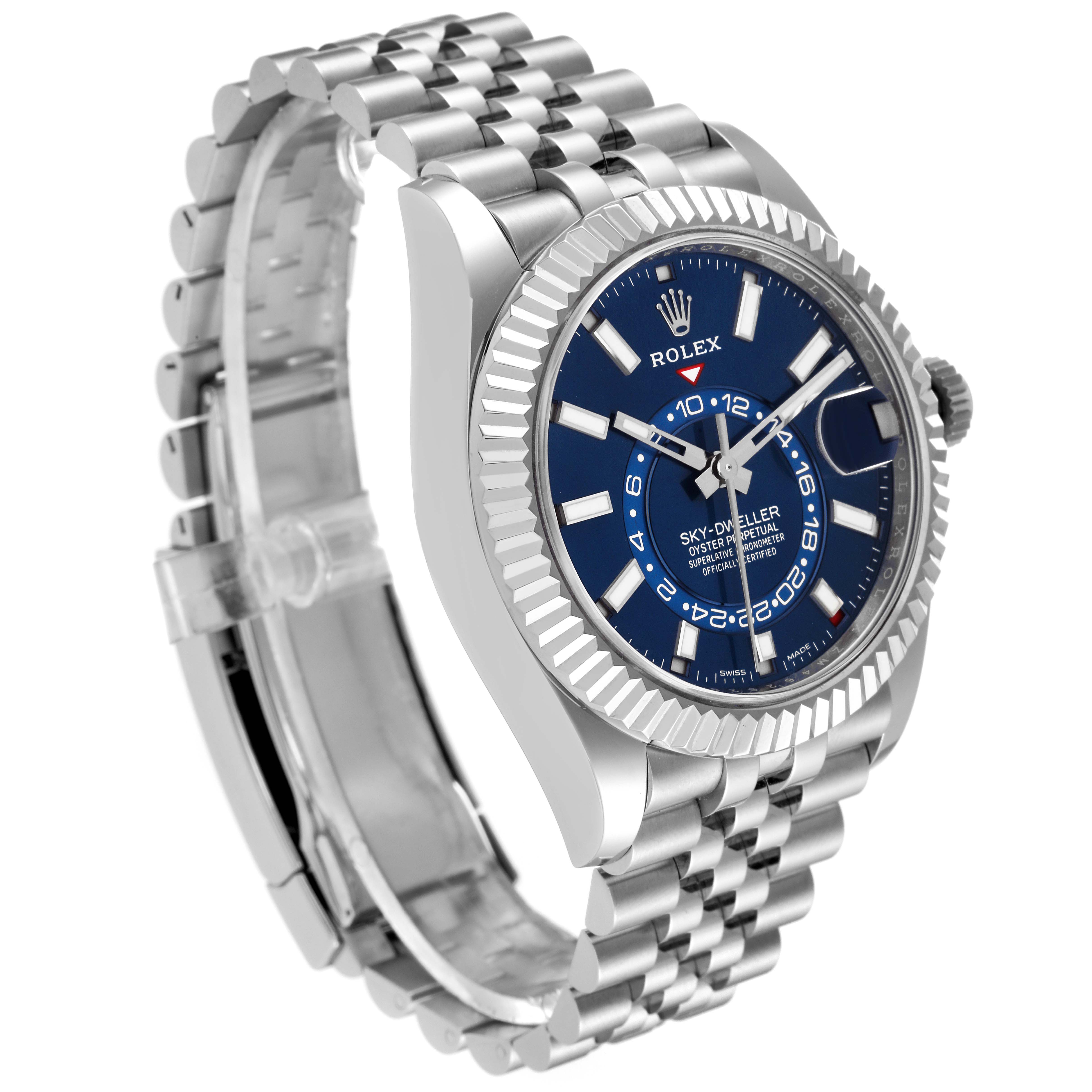 The image shows a side angle of the Rolex Sky-Dweller 326934 Men
s Stainless Steel Blue Dial 326934 Men
s Stainless Steel Blue Dial watch, highlighting its blue dial, bezel, and metallic bracelet.