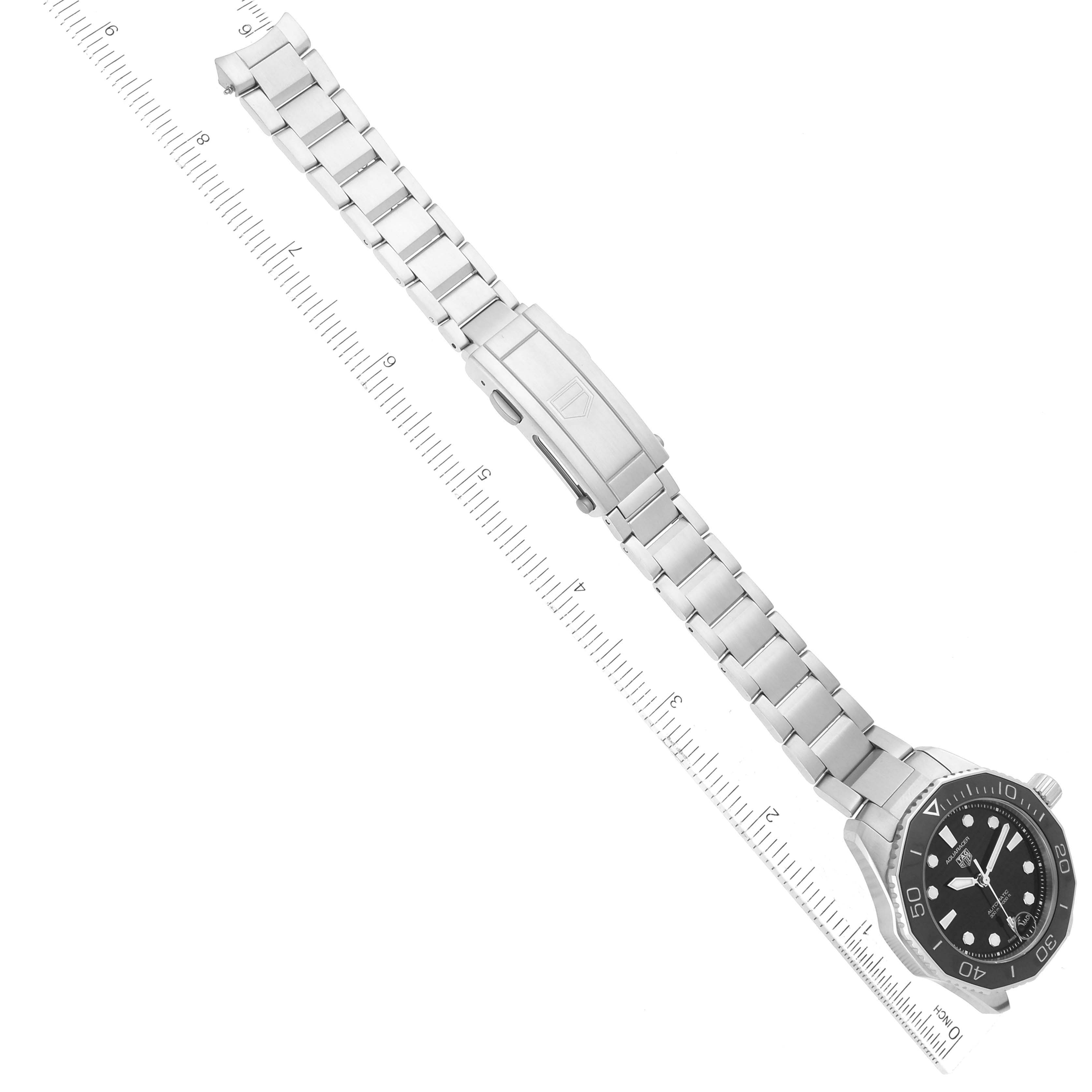 The image shows a Tag Heuer Aquaracer WBP231D Women's Stainless Steel Black Dial WBP231D Women's Stainless Steel Black Dial watch laid flat with its face, bezel, bracelet, and clasp visible, placed next to a ruler.