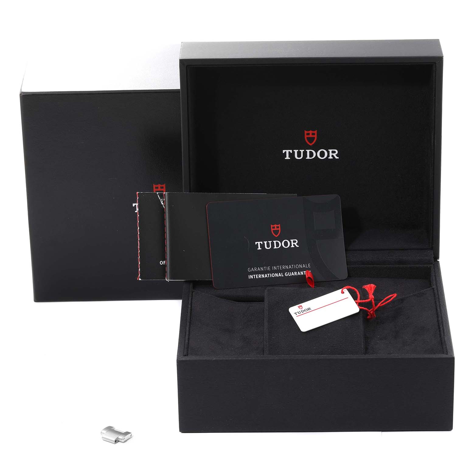 The image shows the box, international guarantee card, and tag of the Tudor Heritage Black Bay 79030N Men
s Stainless Steel Black Dial 79030N Men
s Stainless Steel Black Dial watch from a front angle.