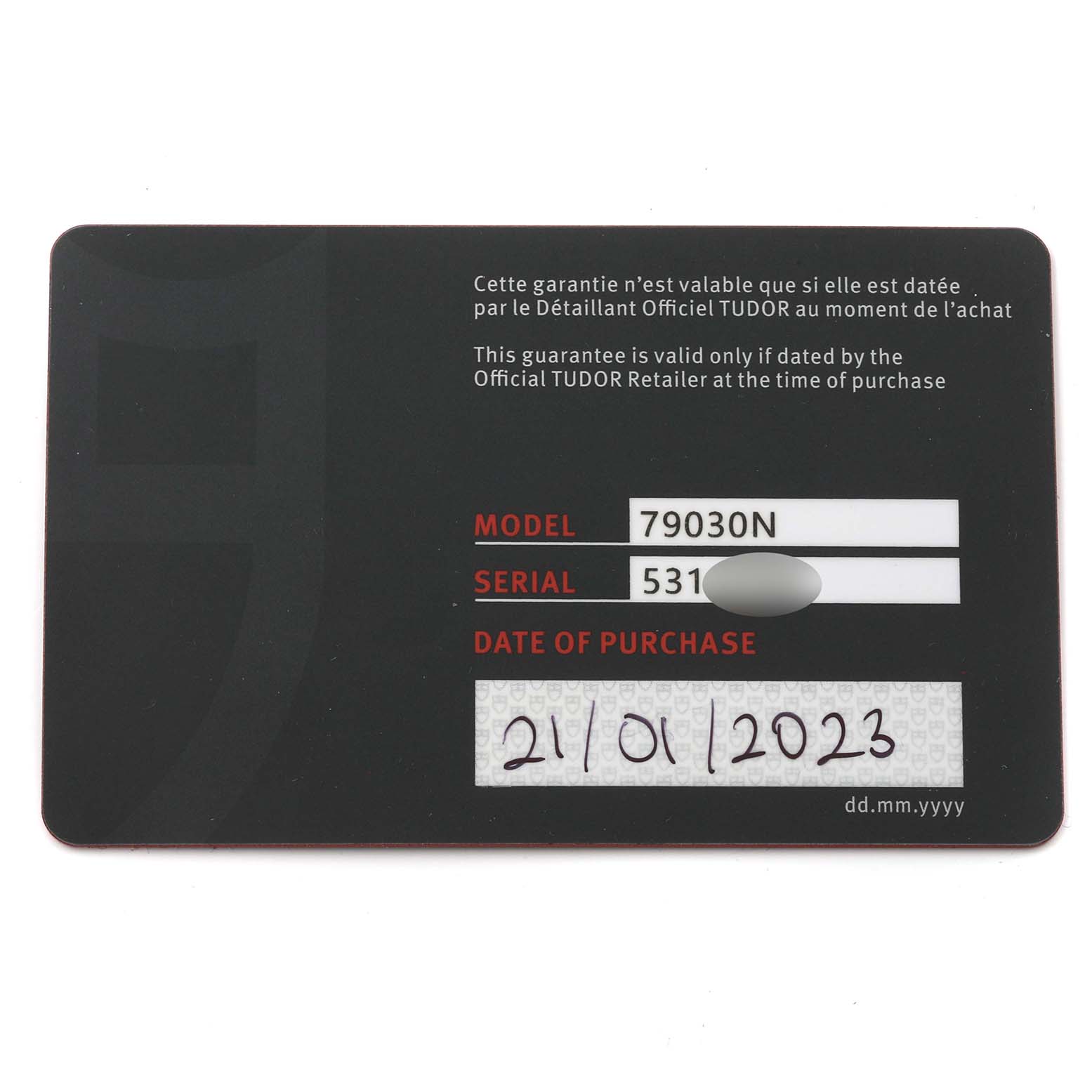 This image shows a warranty card for the Tudor Heritage Black Bay 79030N Men
s Stainless Steel Black Dial 79030N Men
s Stainless Steel Black Dial model 79030N, displaying the serial number and date of purchase.