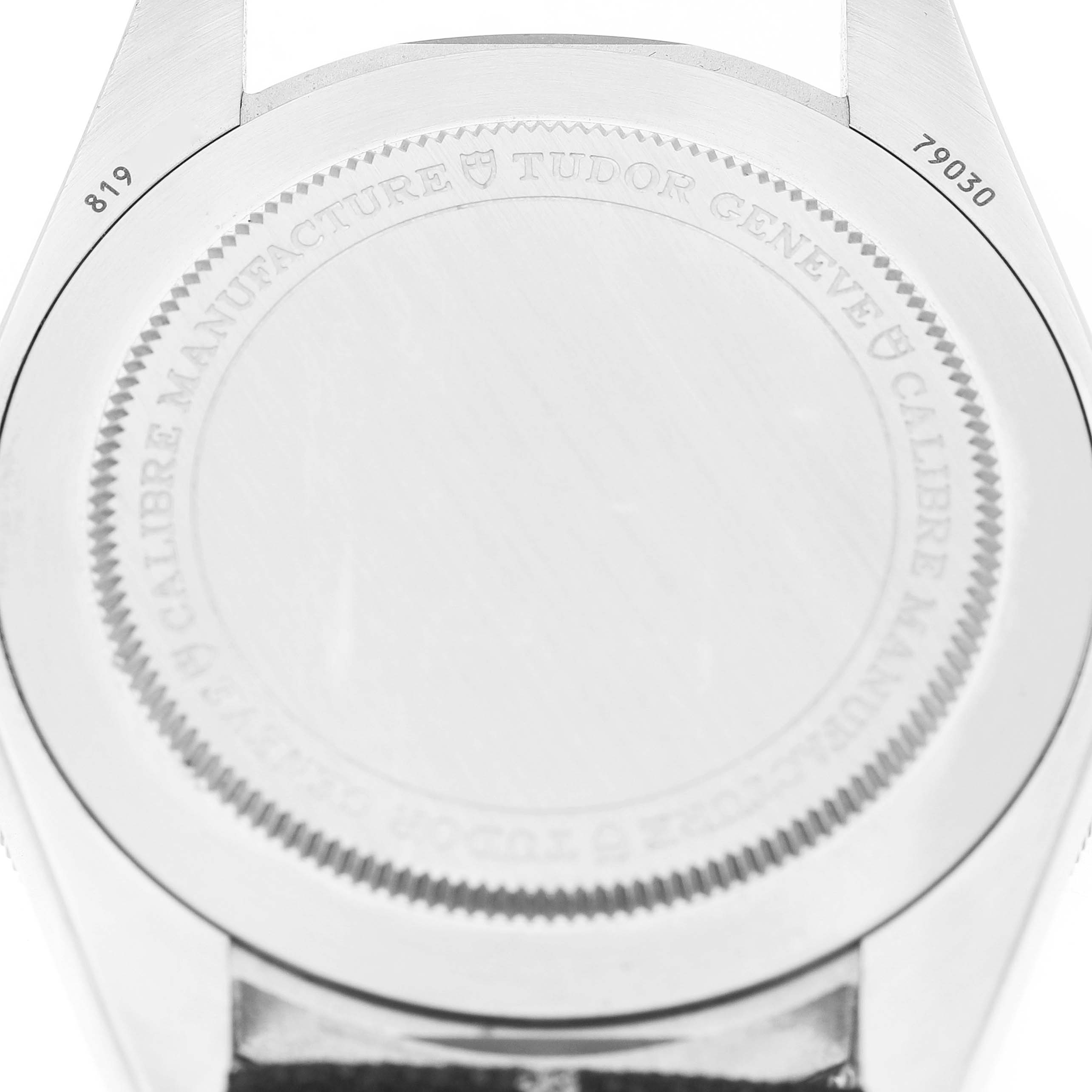 The image shows the back casing of the Tudor Heritage Black Bay 79030 Men's Stainless Steel Brown Dial watch, displaying model details and engravings.