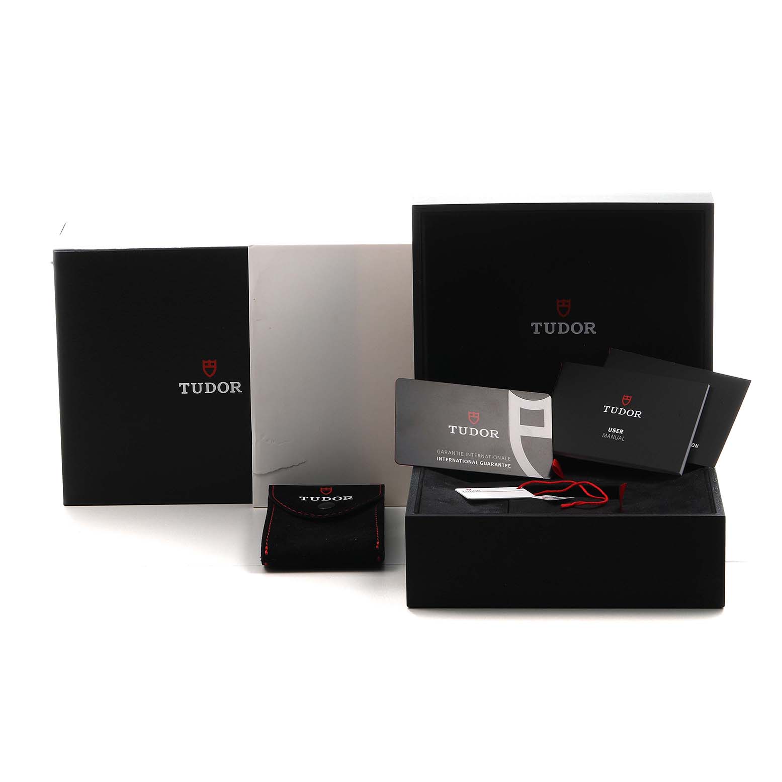 The image shows the packaging and accessories for the Tudor Heritage Black Bay 79030 Men's Stainless Steel Brown Dial watch, including boxes, manuals, and a pouch.