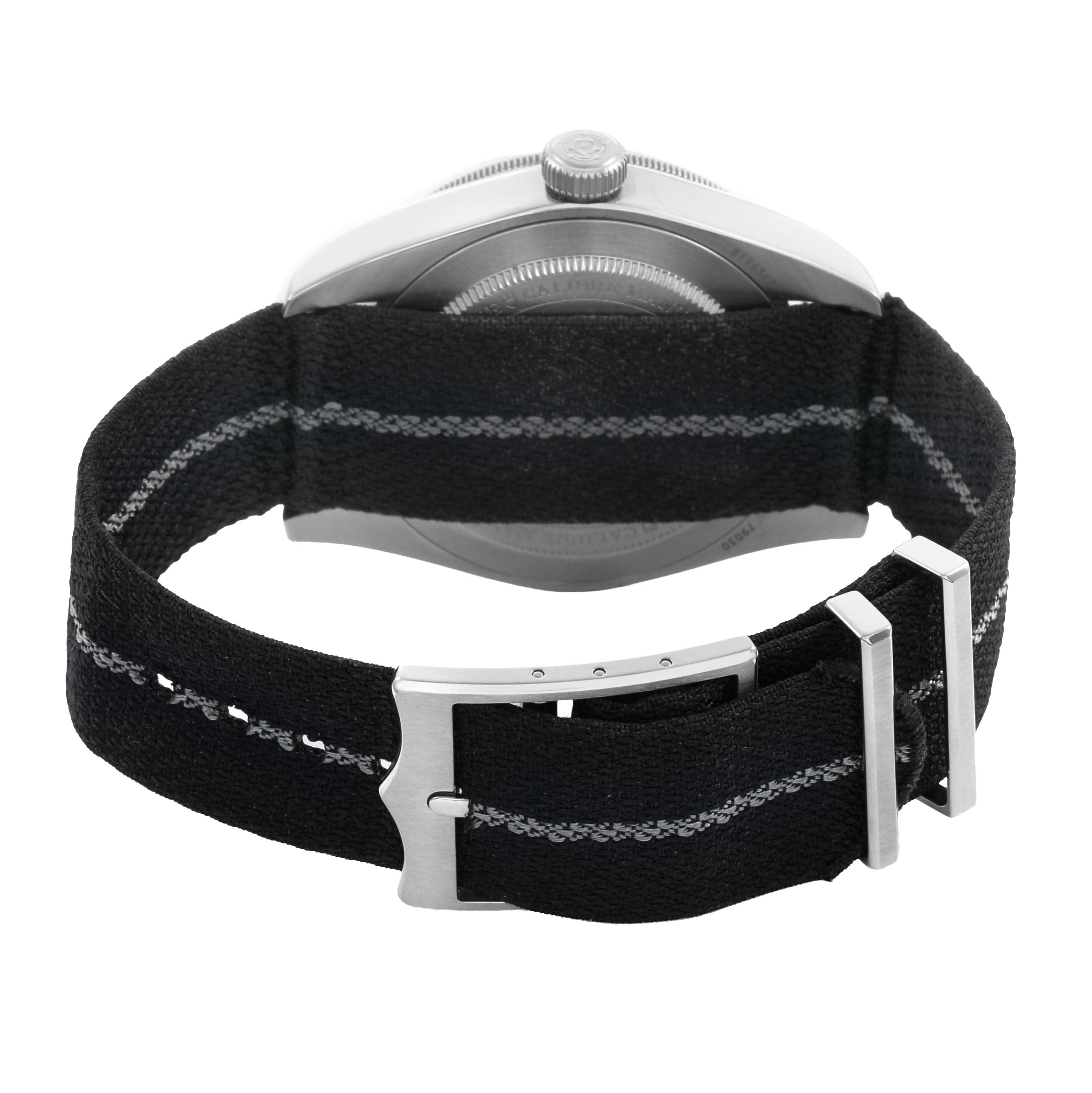 The image shows the back view of a Tudor Heritage Black Bay 79030 Men's Stainless Steel Brown Dial watch, focusing on the NATO strap and clasp.