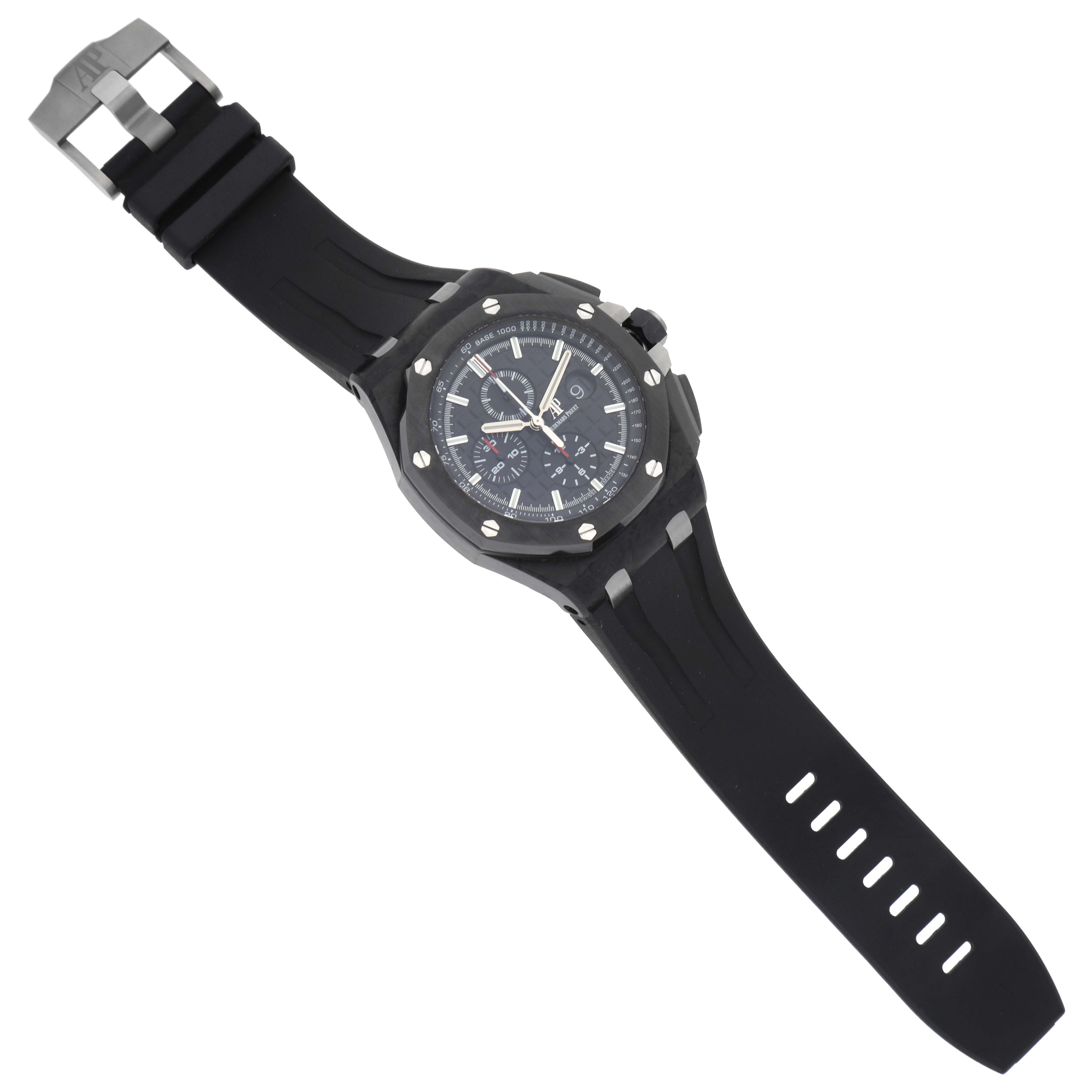 The Audemars Piguet Royal Oak watch is shown from an angled top view, highlighting the face, bezel, and rubber strap.