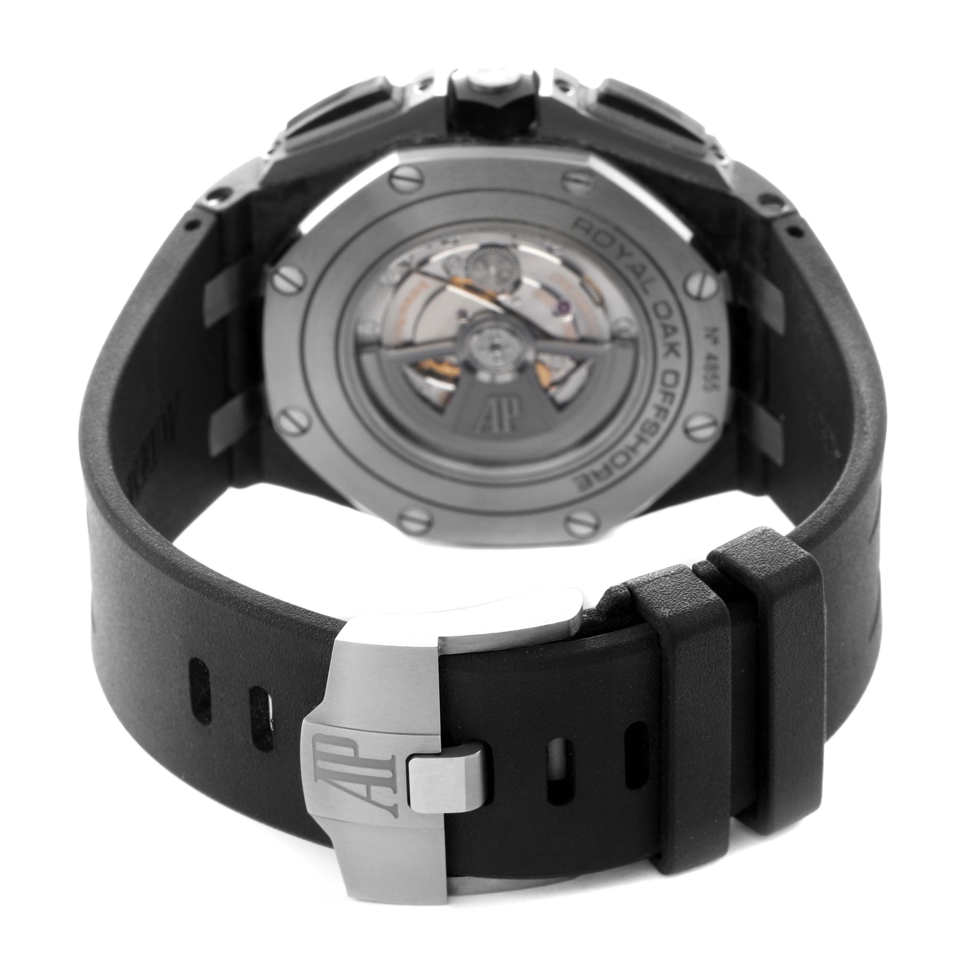 The image shows the back of the Audemars Piguet Royal Oak watch, highlighting the exhibition case back and rubber strap with clasp.