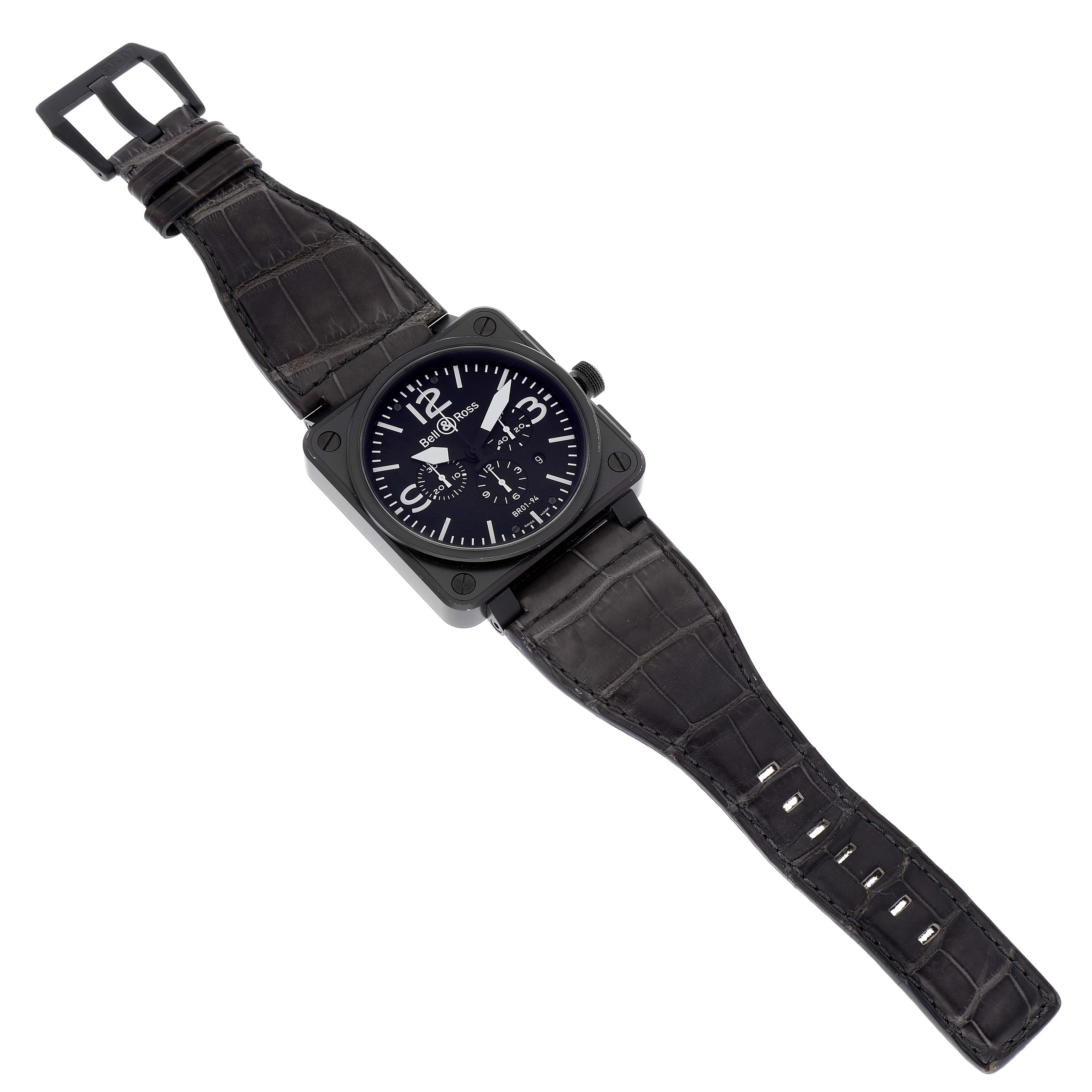 The image shows a top-down view of a Bell & Ross Chronograph watch, including its black strap and square face.