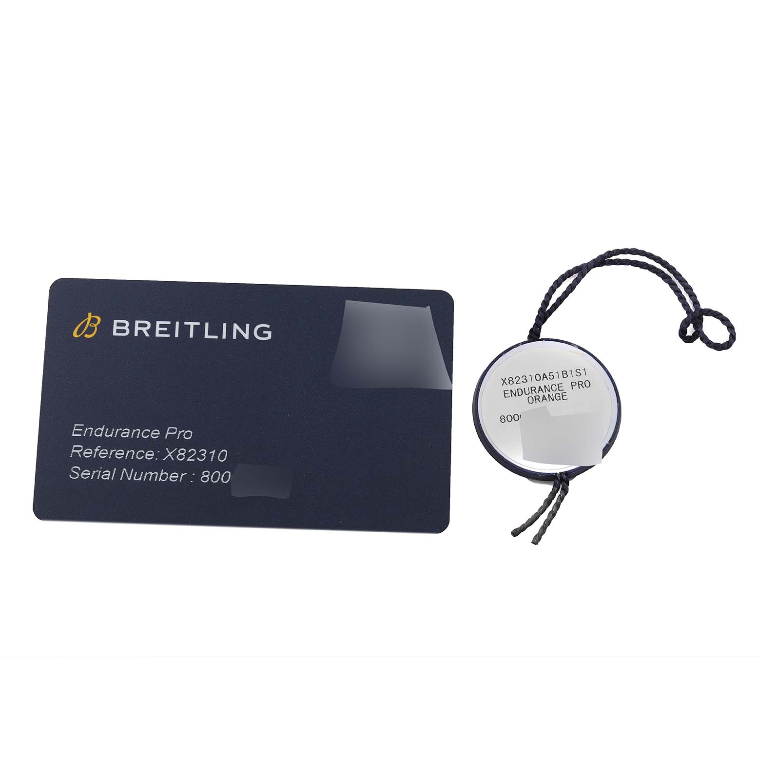 The image shows a Breitling Endurance Pro X82310 watch's authentication card and hang tag with model, reference, and serial number details.