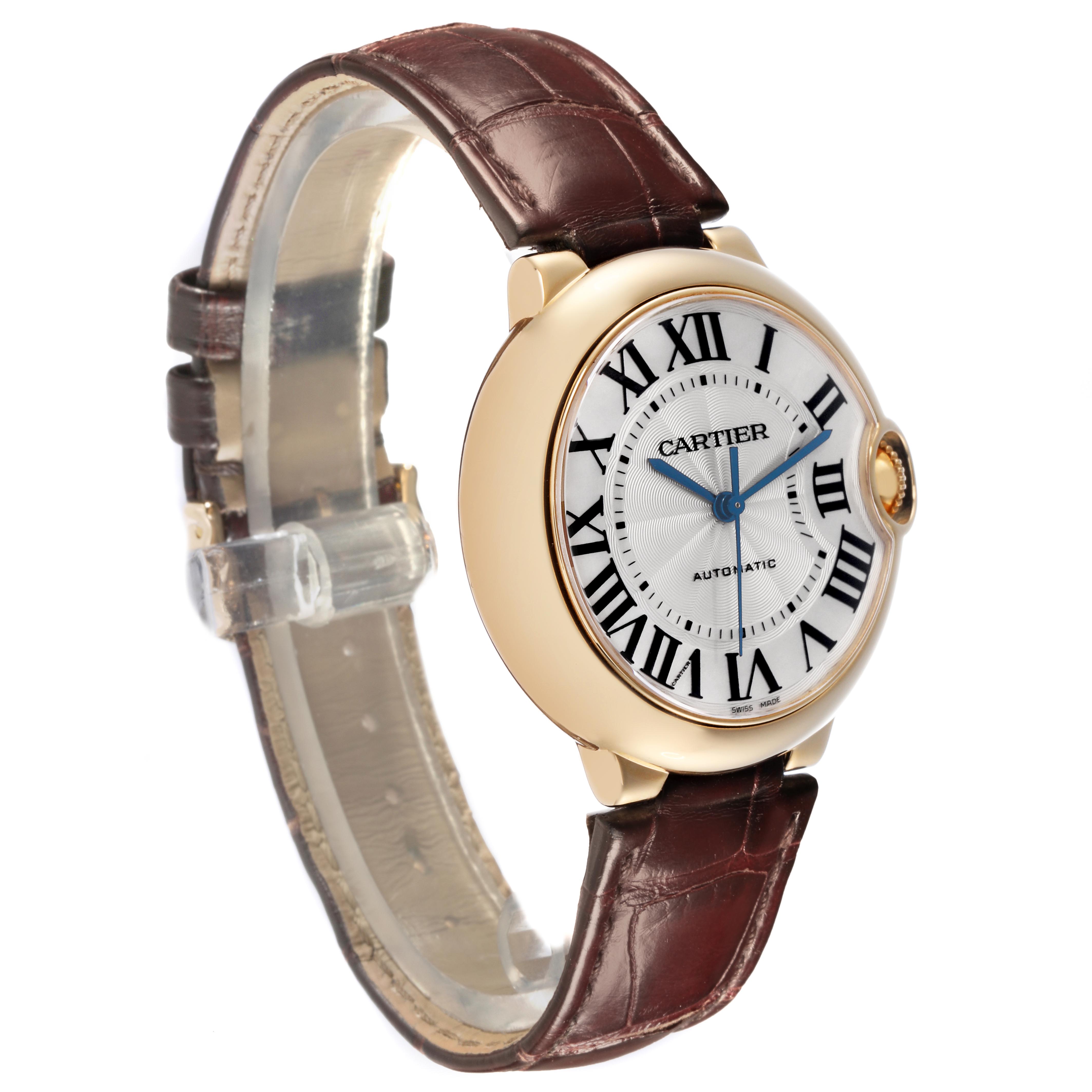 The Cartier Ballon Bleu W6900356 Men
s Yellow Gold Silver Dial W6900356 Men
s Yellow Gold Silver Dial watch is shown at a three-quarter angle, highlighting its dial, bezel, crown, and leather strap.