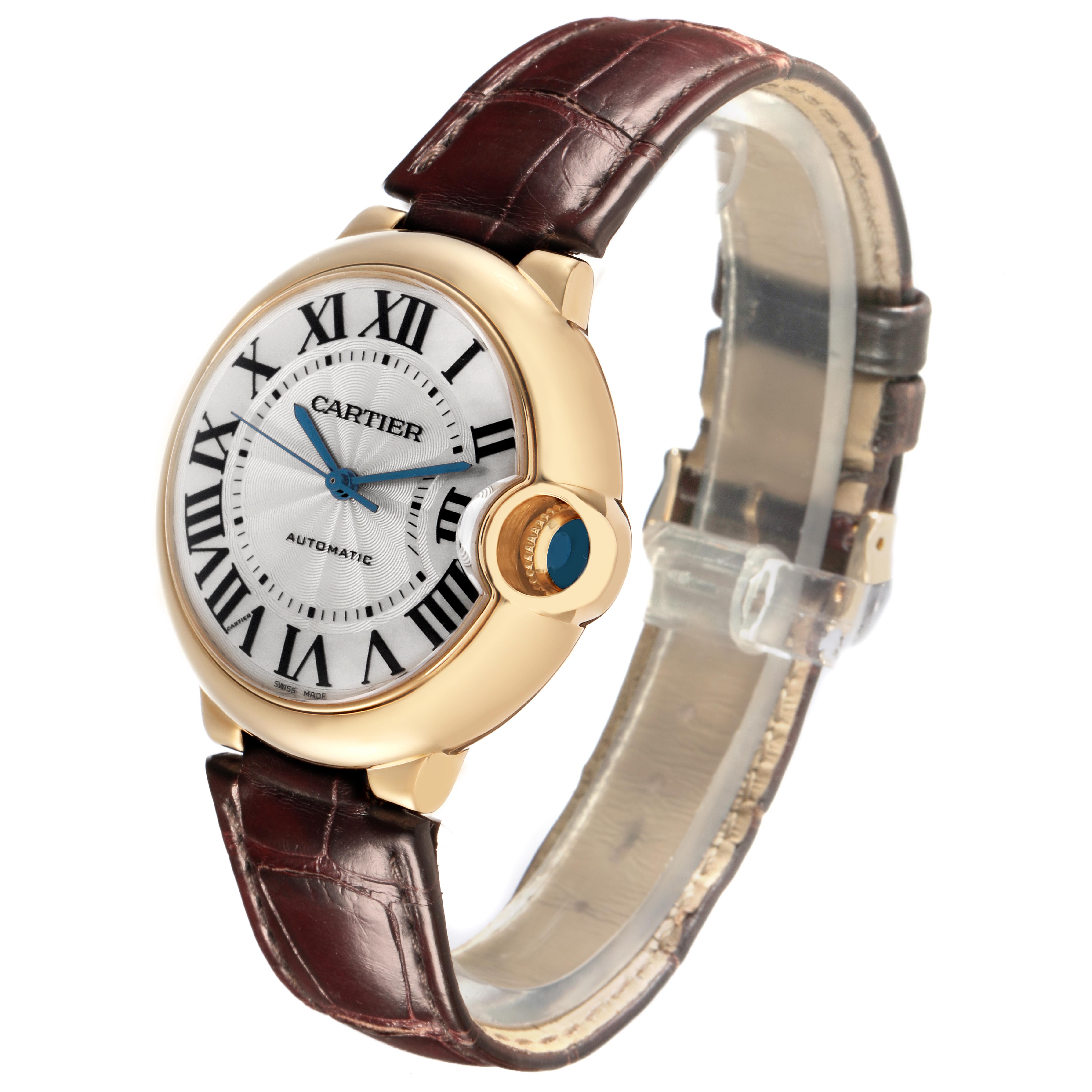 The Cartier Ballon Bleu W6900356 Men
s Yellow Gold Silver Dial W6900356 Men
s Yellow Gold Silver Dial watch is shown at a slight angle, displaying the face, crown, and leather strap.