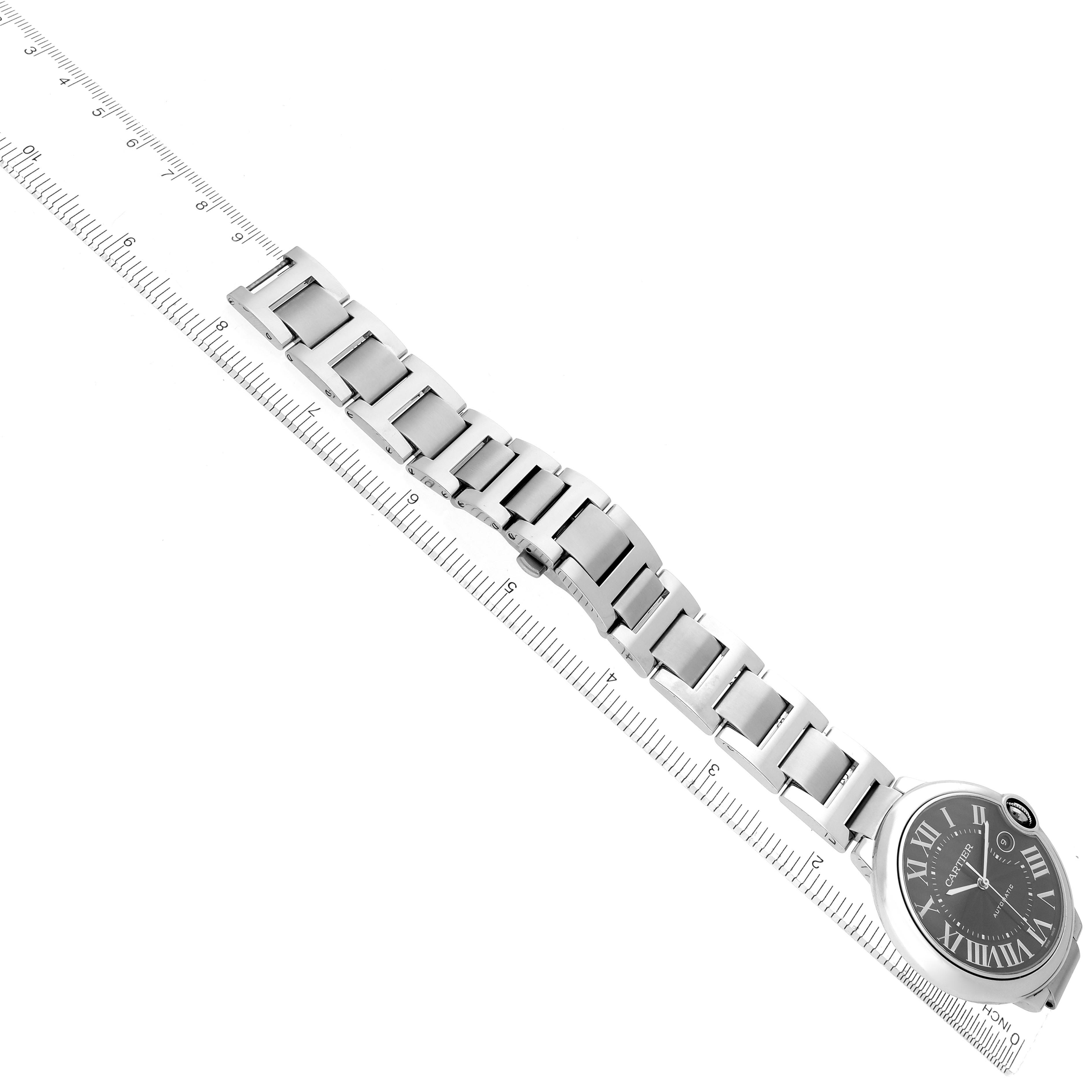The image shows a side view of a Cartier Ballon Bleu W6920042 Men
s Stainless Steel Black Dial W6920042 Men
s Stainless Steel Black Dial watch, featuring its face and metal bracelet, aligned with a ruler.