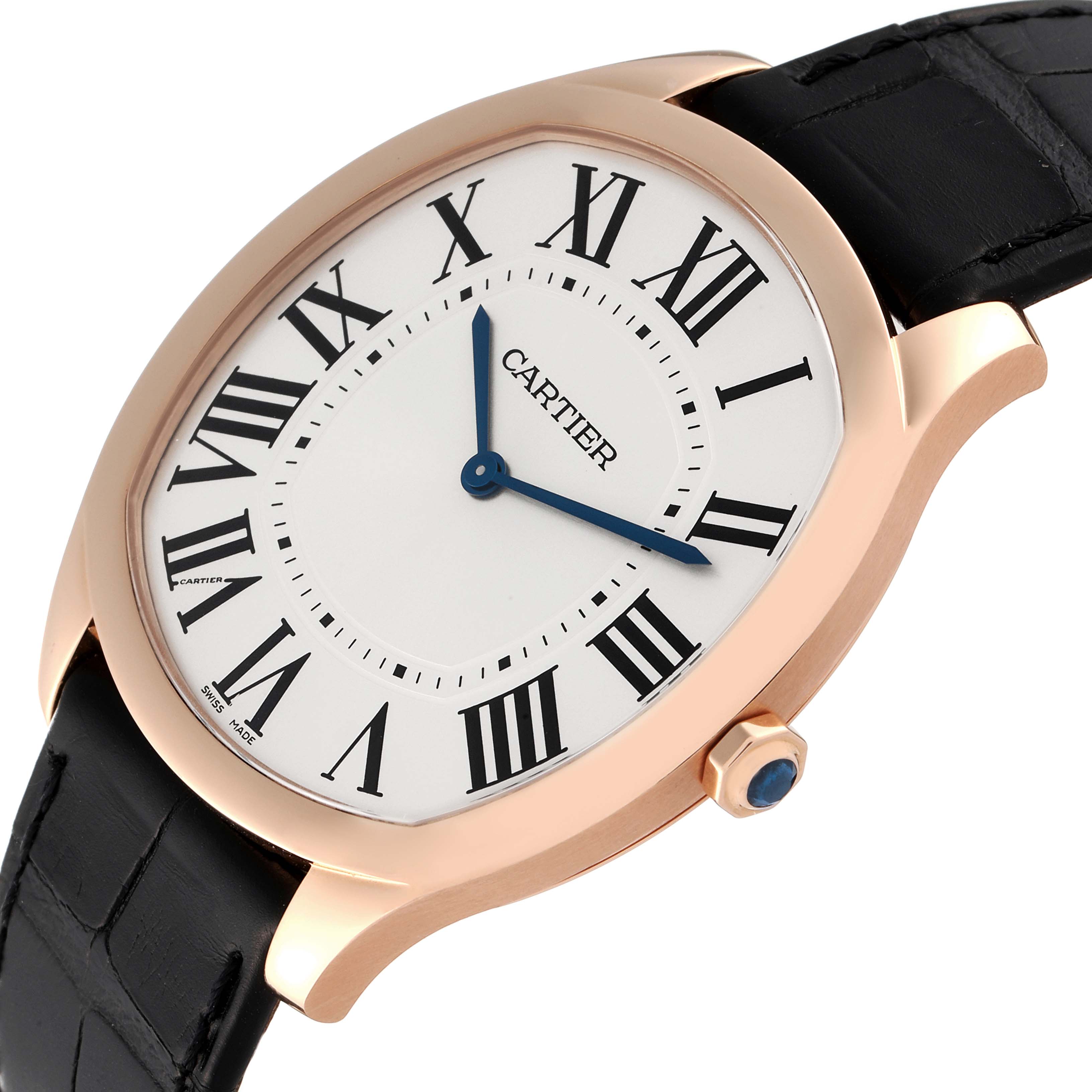 The image shows a close-up of a Drive de Cartier watch by Cartier, highlighting the dial, Roman numerals, and crown with a gem.