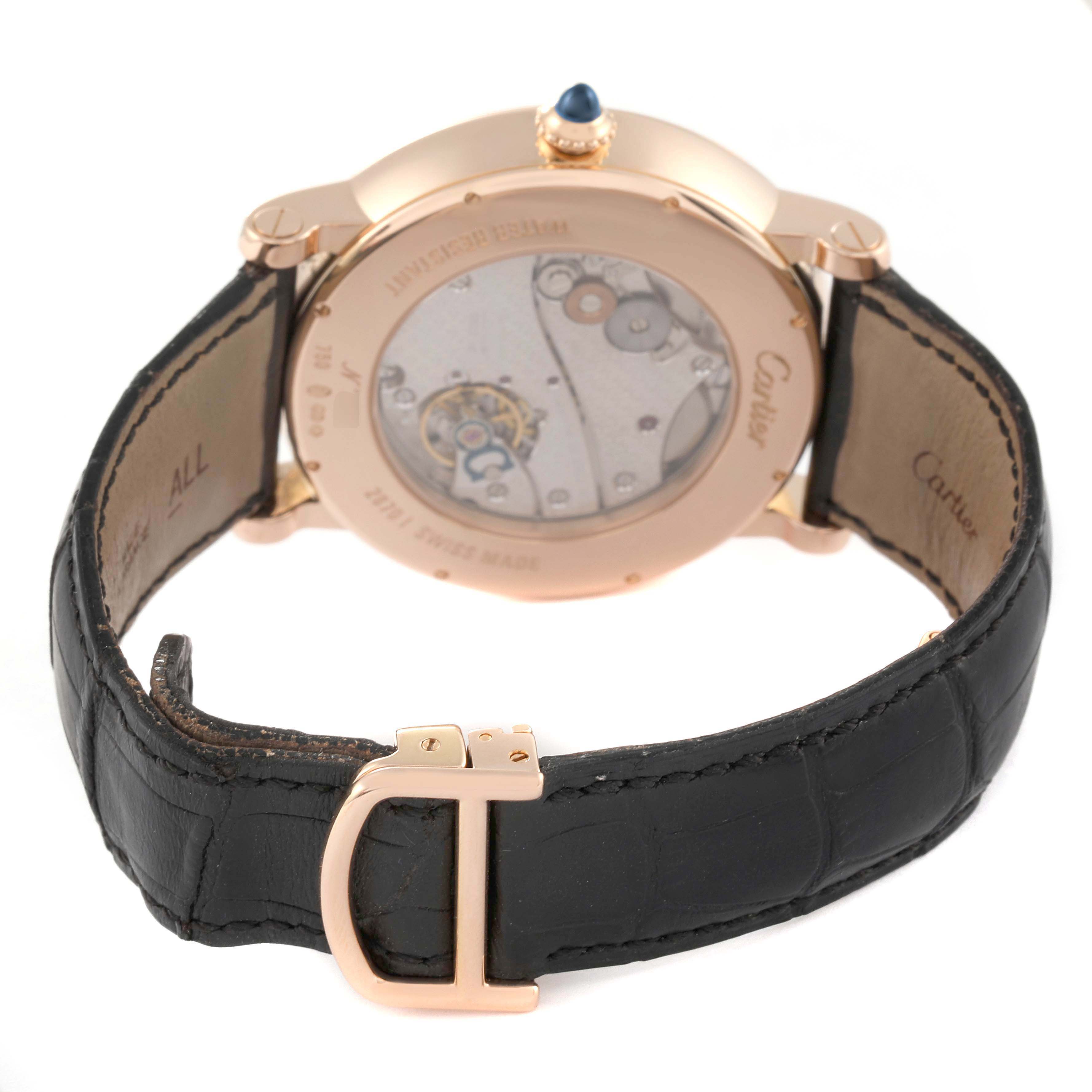The Cartier Rotonde W1550251 Men's Rose Gold Silver Dial watch is shown from the back, highlighting its transparent case back and black leather strap.