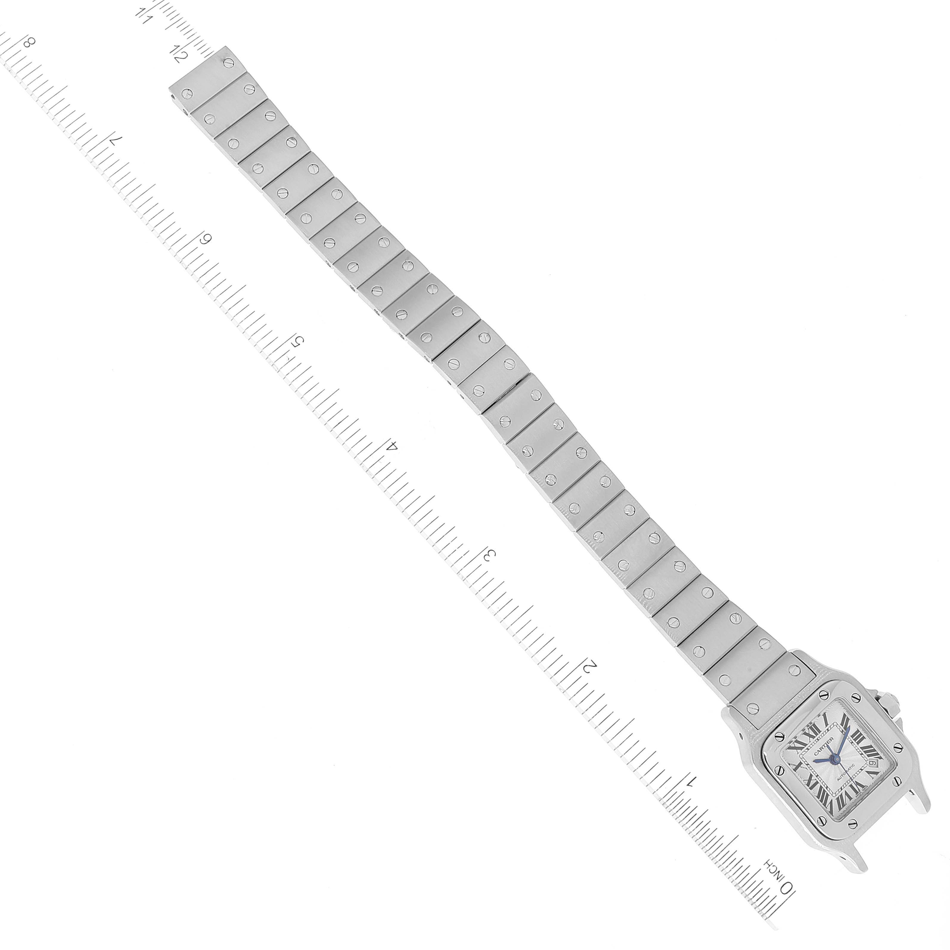 The image shows a top-down view of a Santos model watch by Cartier, including the face and entire metal bracelet with a ruler for scale.