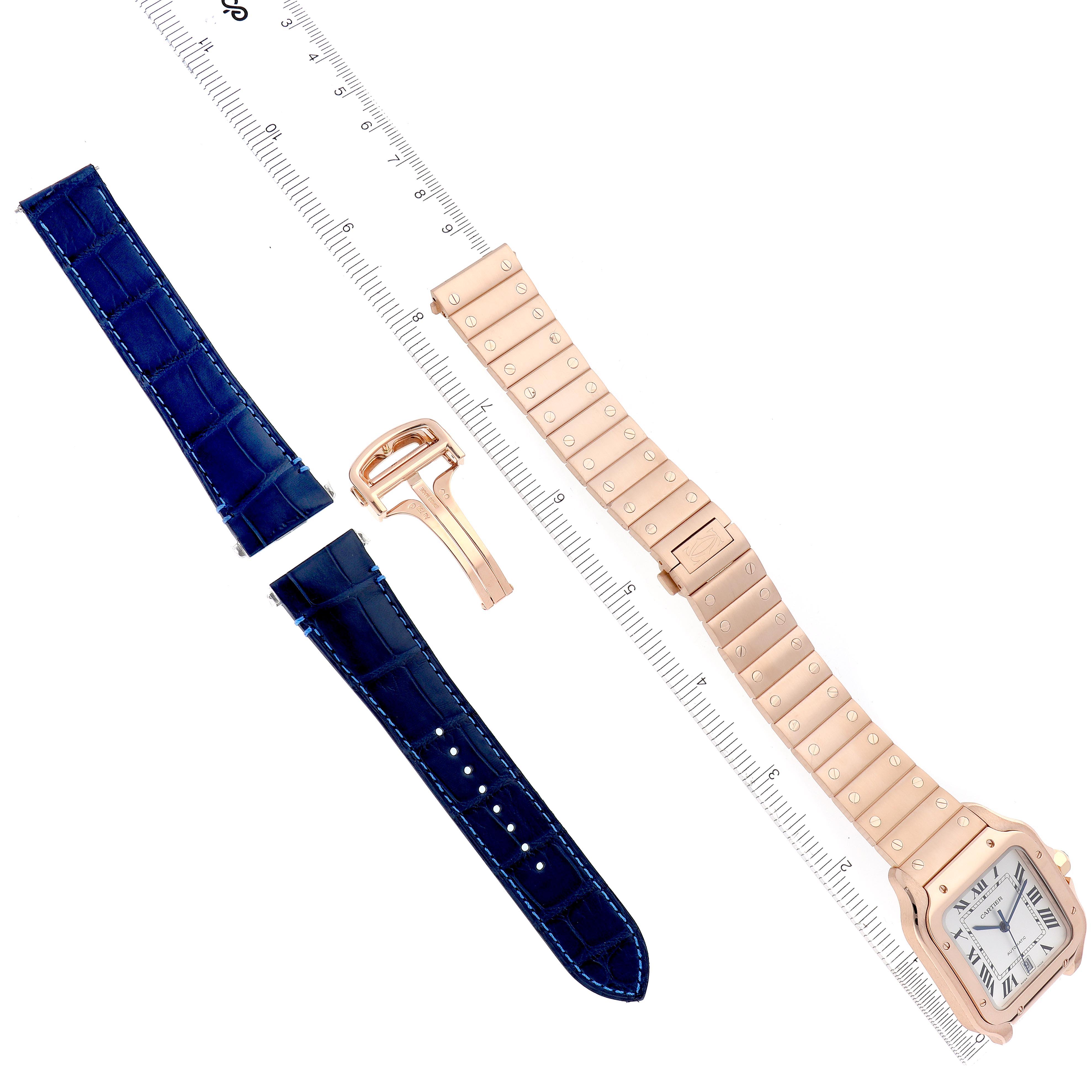 The image shows a Cartier Santos WGSA0018 Men
s Rose Gold Silver Dial WGSA0018 Men
s Rose Gold Silver Dial watch with a metal bracelet, blue leather straps, and a clasp, viewed from above.