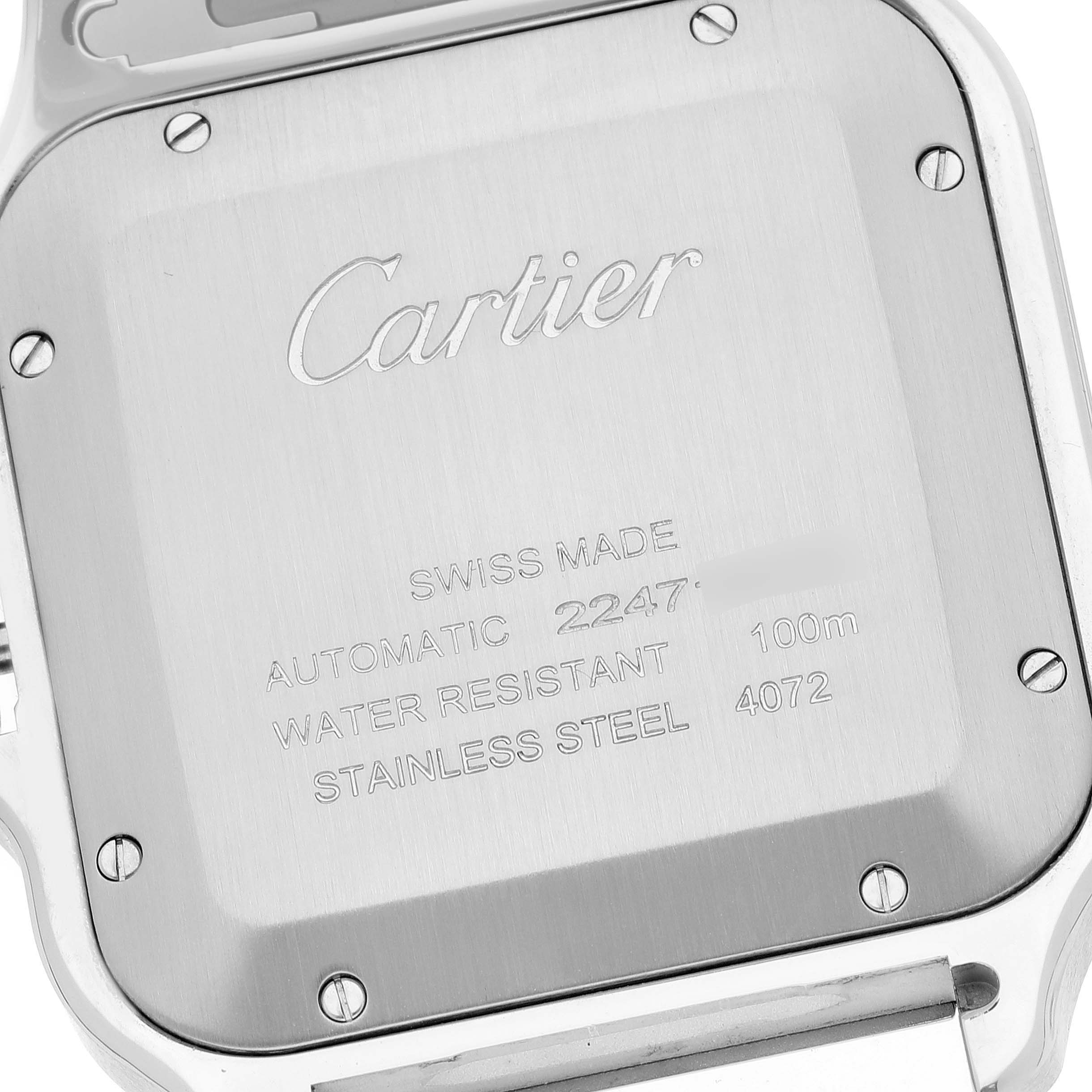 The image shows the back casing of a Santos model watch by Cartier, including engraved details and screws.
