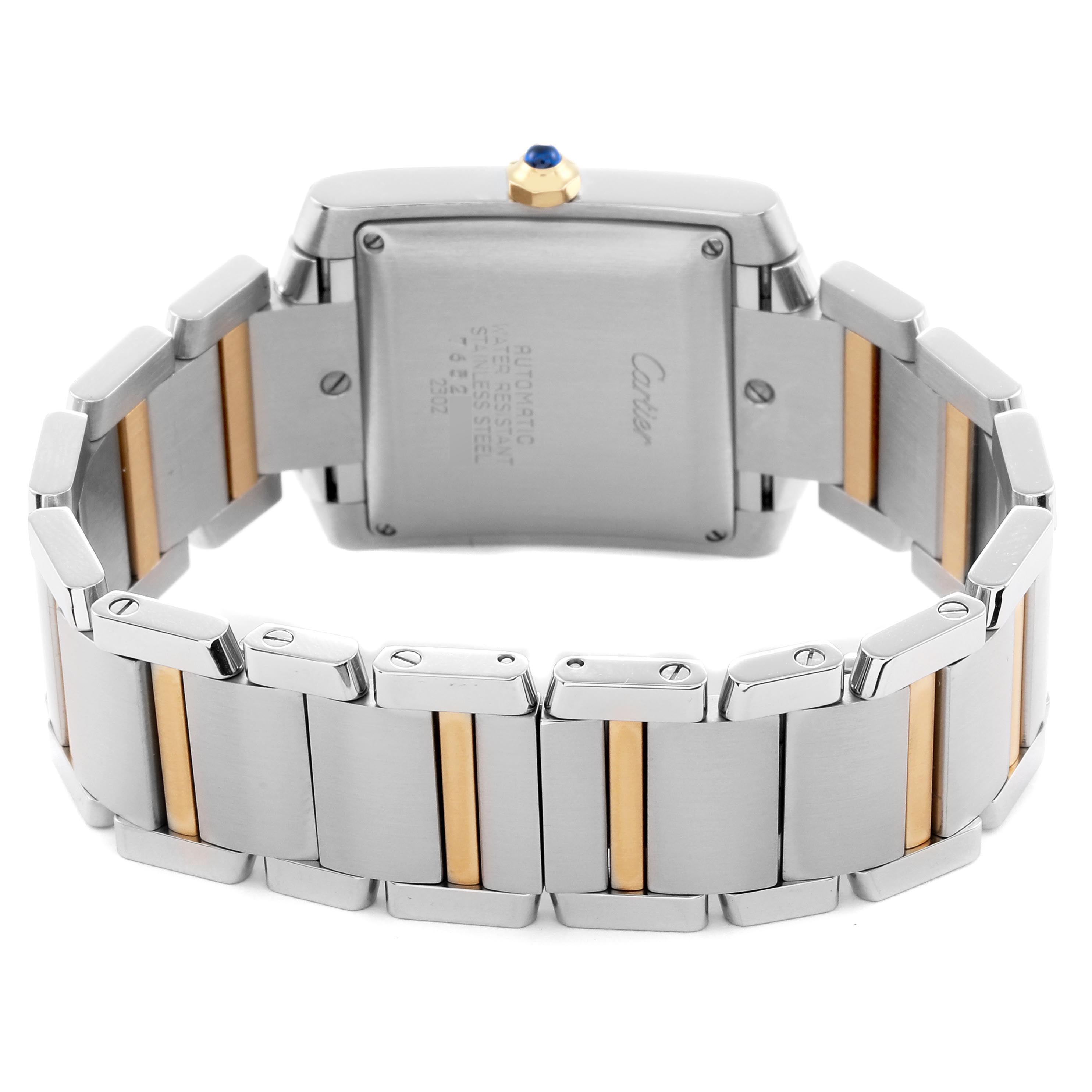 The Cartier Tank Française watch is shown from the back, highlighting the case back and two-tone metal bracelet.