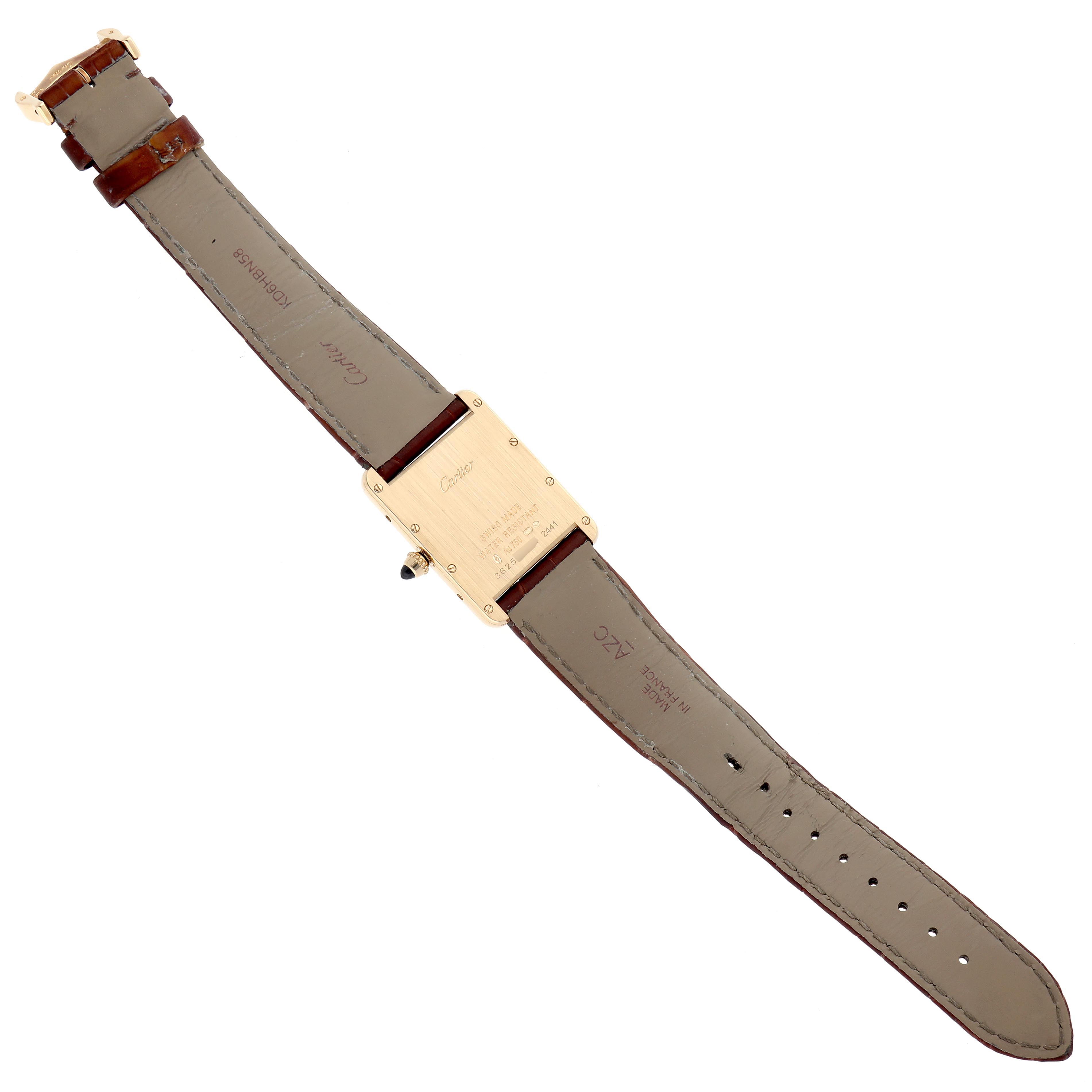 The Cartier Tank Louis W1529756 Men
s Yellow Gold Silver Dial W1529756 Men
s Yellow Gold Silver Dial watch is shown from the back, displaying the case back and full leather strap.