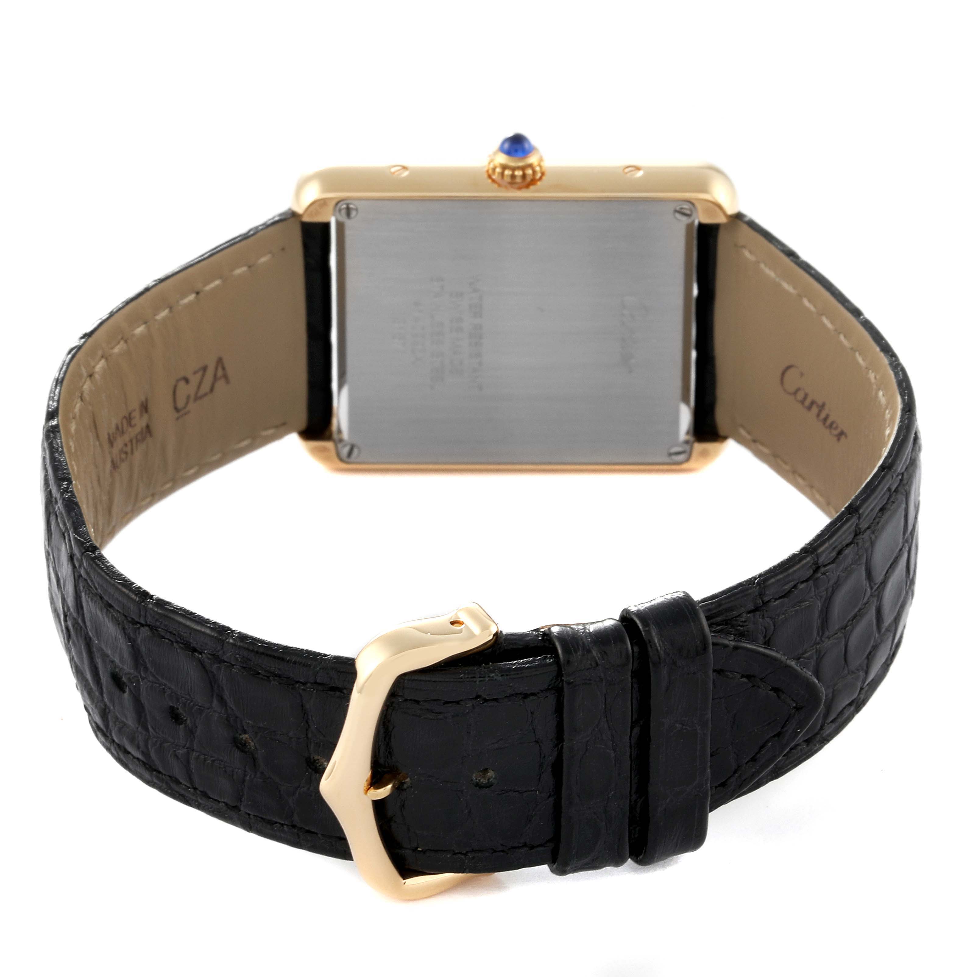 The image shows the back view of the Cartier Tank Solo W5200004 Men's Yellow Gold Silver Dial W5200004 Men's Yellow Gold Silver Dial watch with its caseback, black leather strap, and gold buckle.