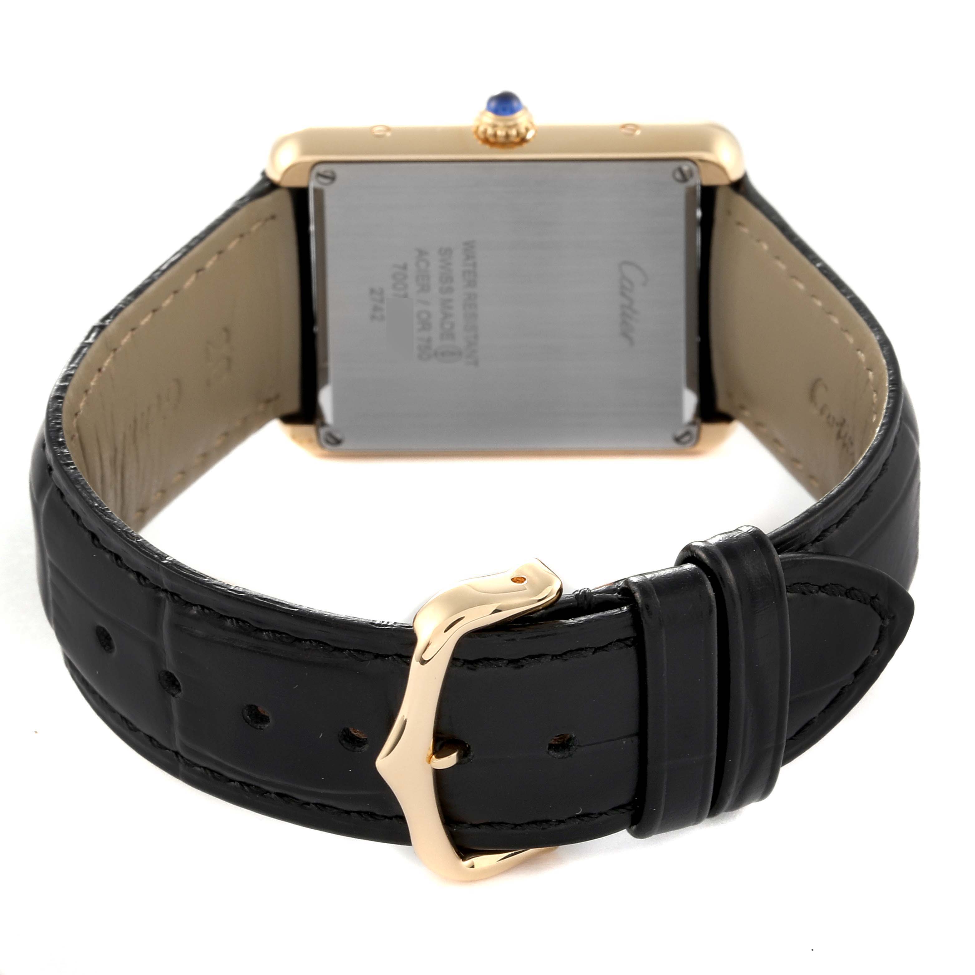 The image shows the back view of the Cartier Tank Solo W1018855 Men's Yellow Gold Silver Dial W1018855 Men's Yellow Gold Silver Dial watch, featuring the case back and black leather strap with a gold buckle.