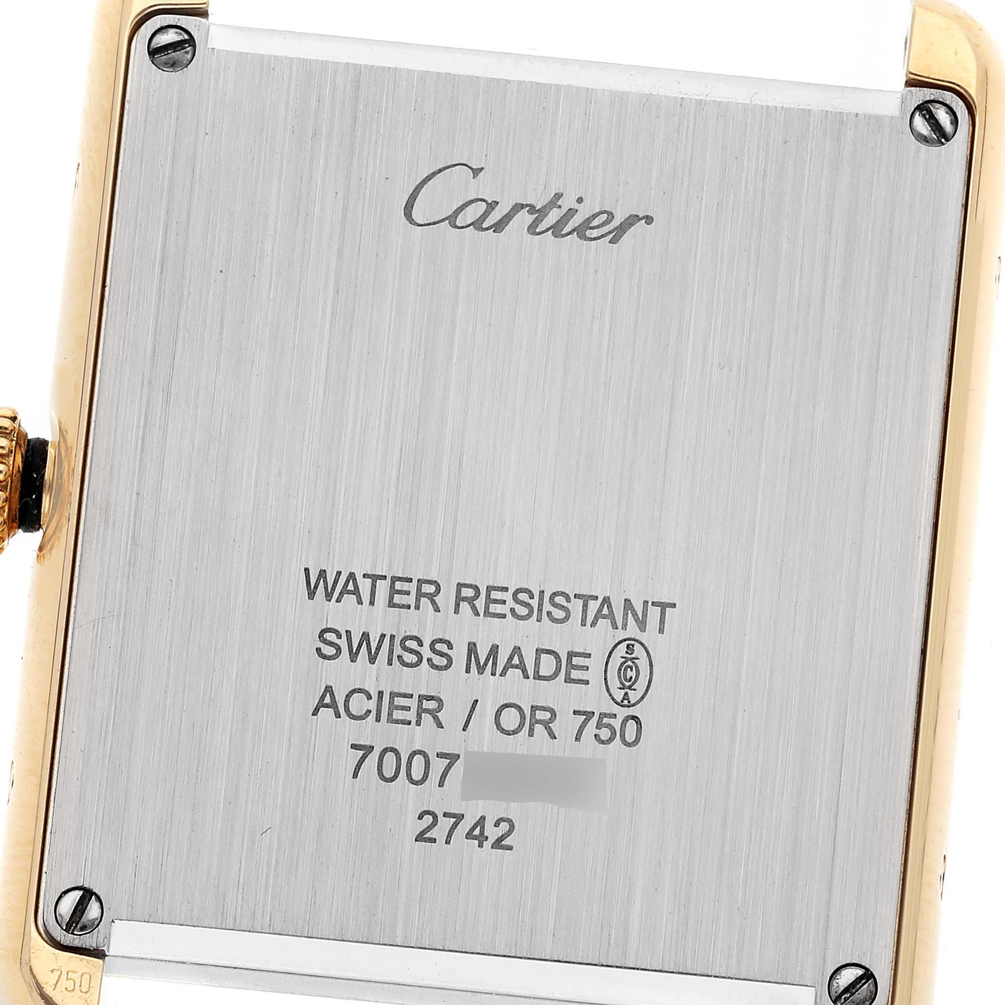 The image shows the back case of a Cartier Tank Solo W1018855 Men's Yellow Gold Silver Dial W1018855 Men's Yellow Gold Silver Dial watch, including its screws, serial number, and inscriptions.
