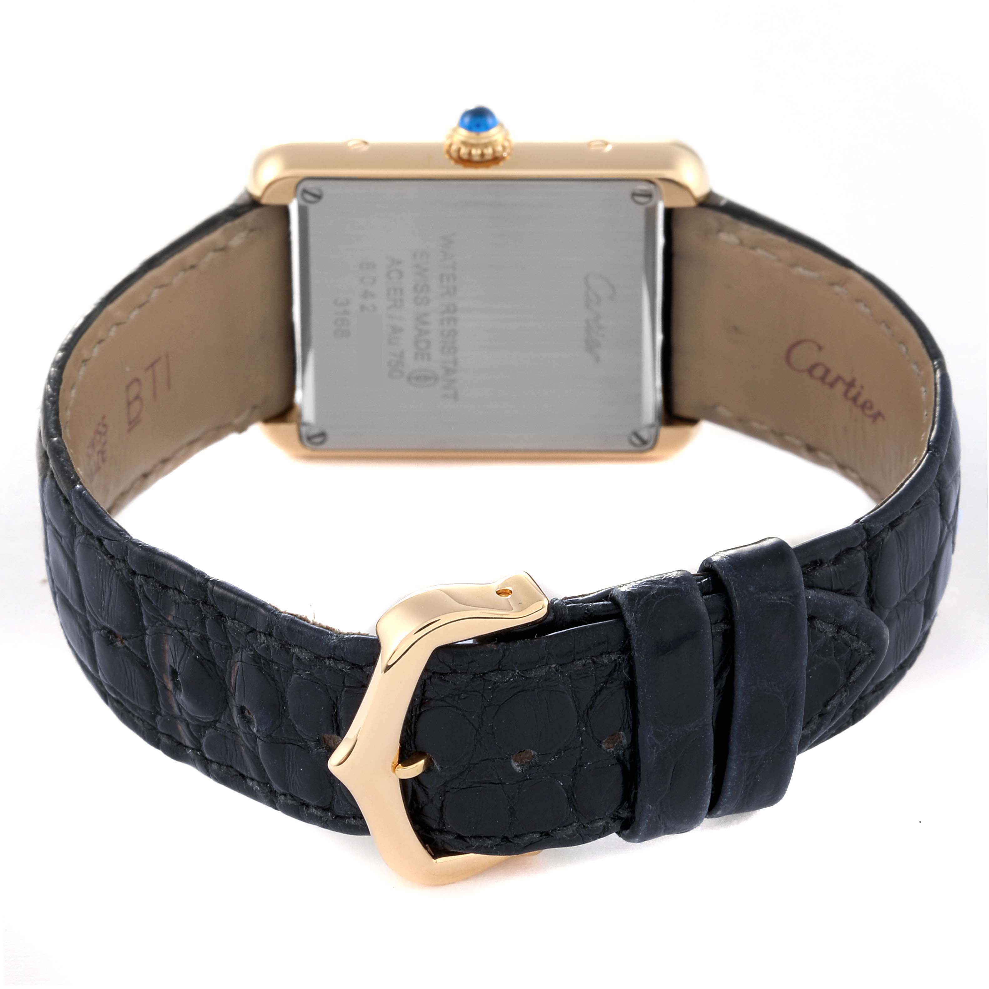 The image shows the back of the Cartier Tank Solo W5200002 Women's Yellow Gold Silver Dial W5200002 Women's Yellow Gold Silver Dial watch, highlighting the buckle, strap, and case back with inscriptions.